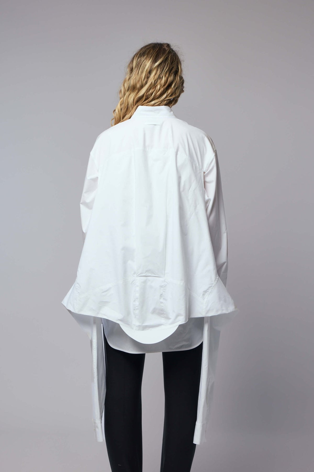 Model wearing white Jean Paul Gaultier oversized shirt with pointed collar
