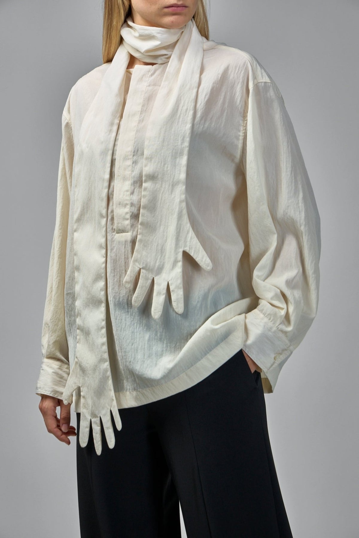 Back view of oversized cream blouse showing dropped shoulders and loose silhouette