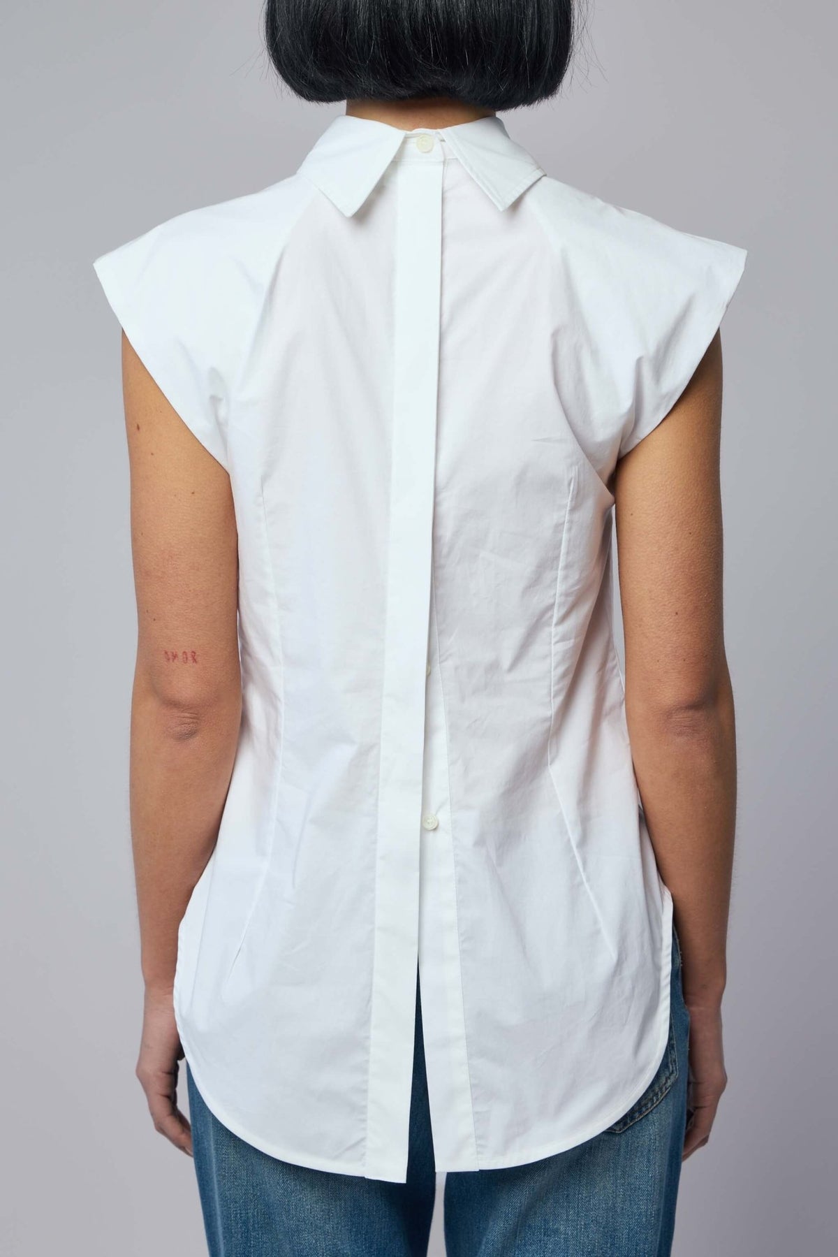 Back view of Jean Paul Gaultier sleeveless blouse with curved hemline, view 6