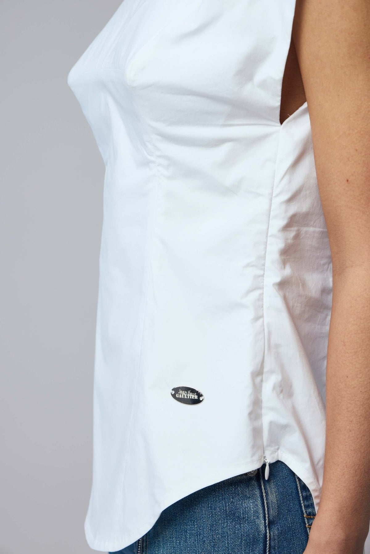 Back view of Jean Paul Gaultier sleeveless blouse with curved hemline