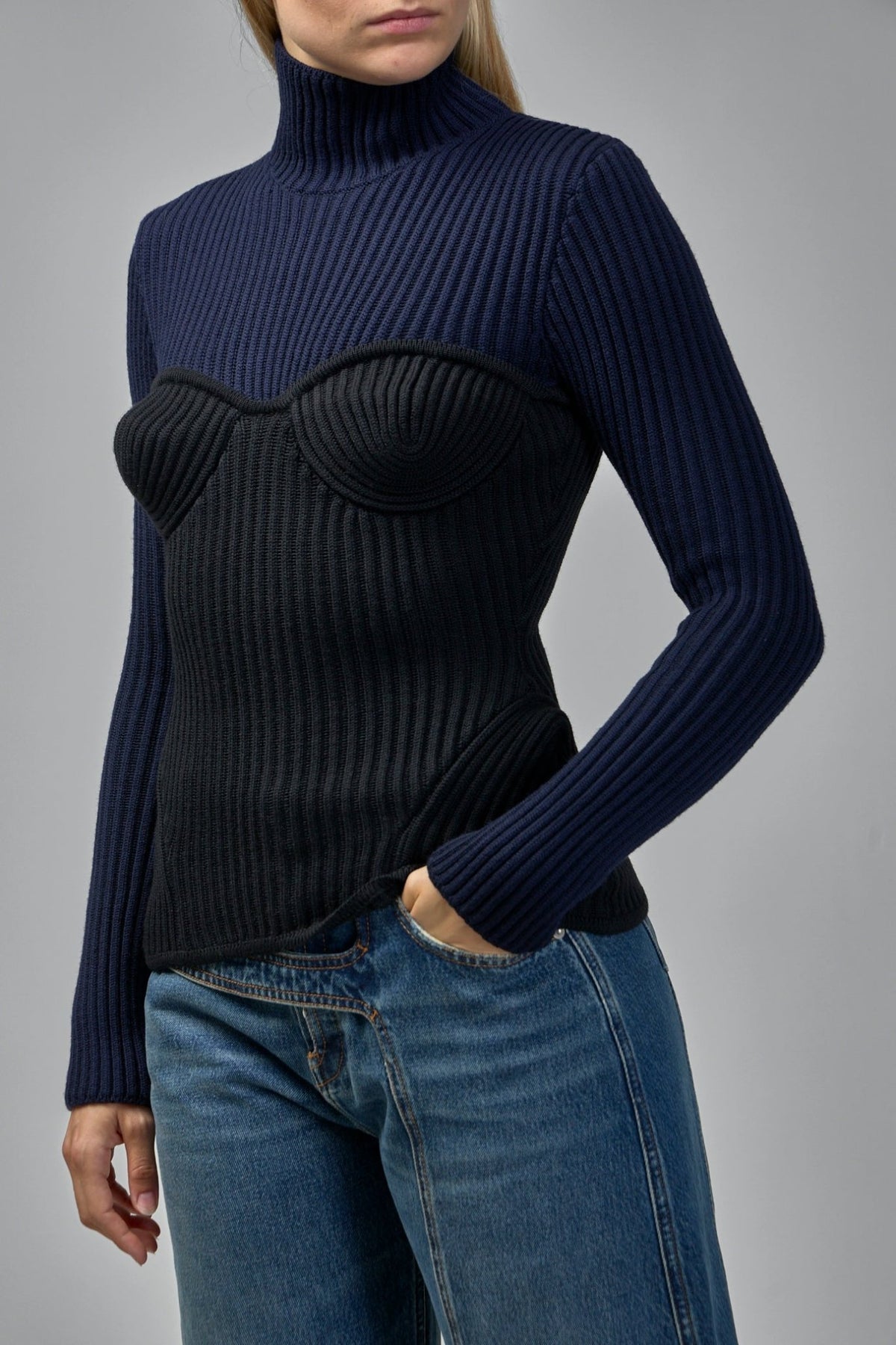 Back view of Jean Paul Gaultier high neck sweater displaying ribbed knit construction