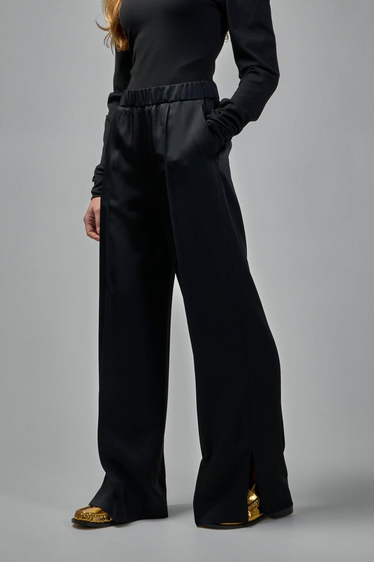 Full-length view of Jil Sander black wide-leg trousers styling