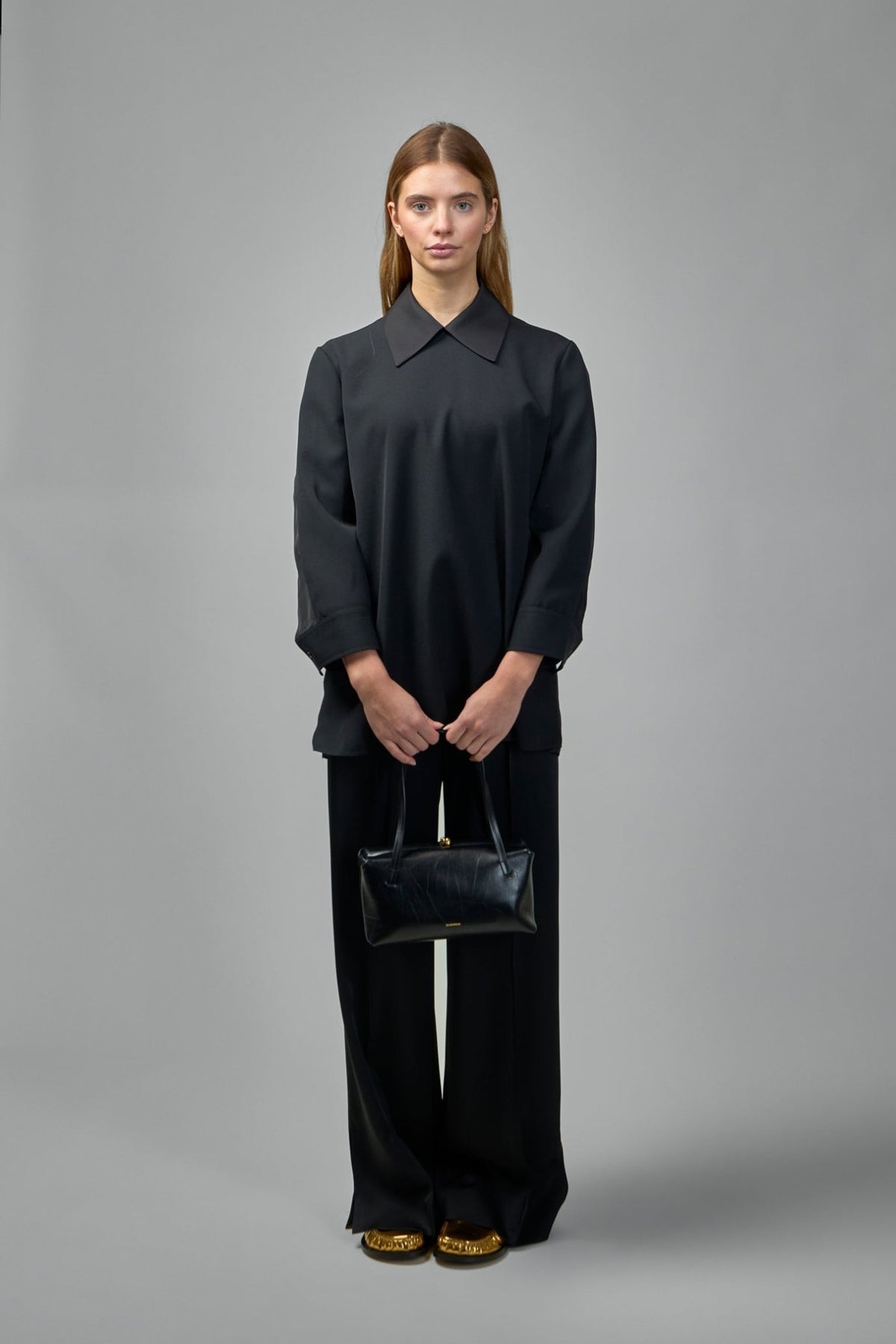 Side profile showing flowing silhouette of satin wide-leg pants