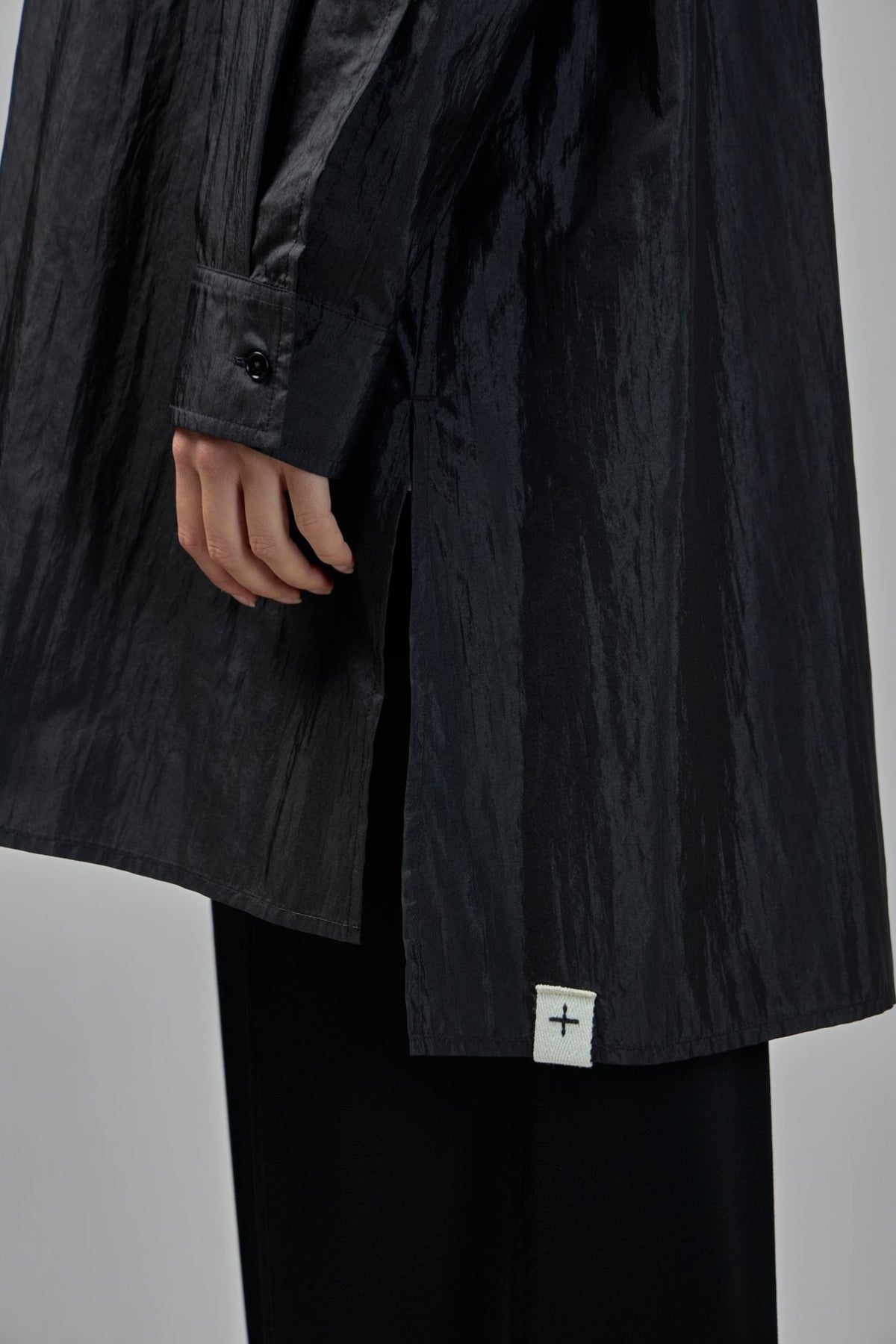Styling detail of button-down closure on elegant Jil Sander blouse