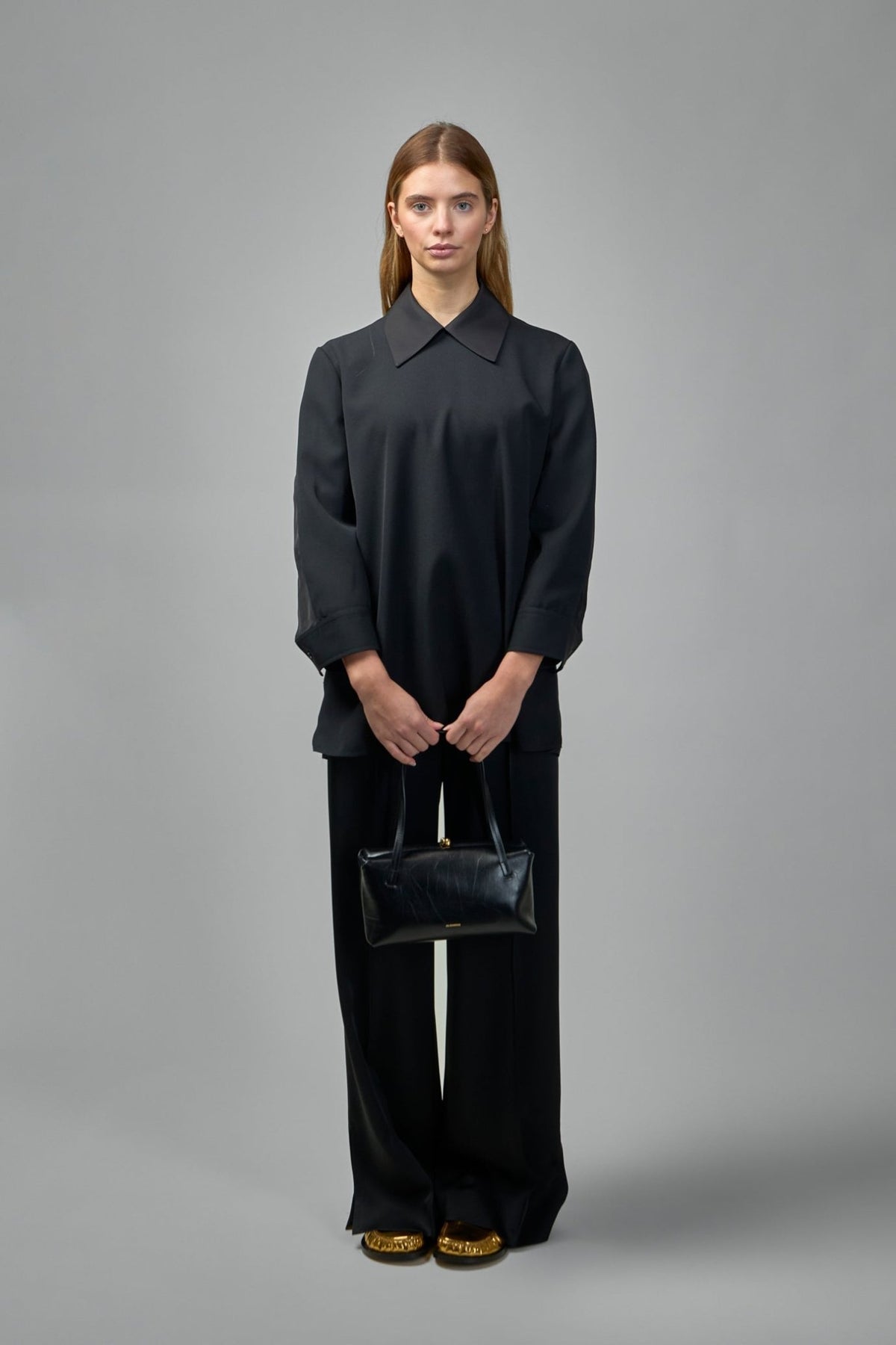 Styling detail of Jil Sander wool top collar and sleeve construction