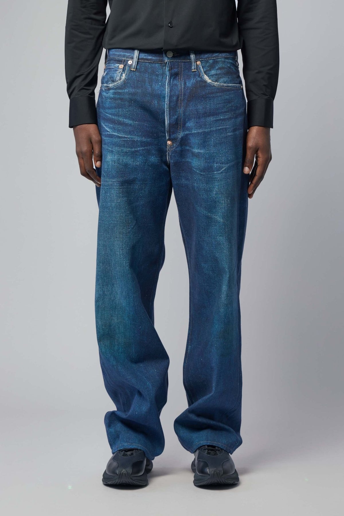 Close-up detail of Junya Watanabe wide-leg pants showing wool texture and construction