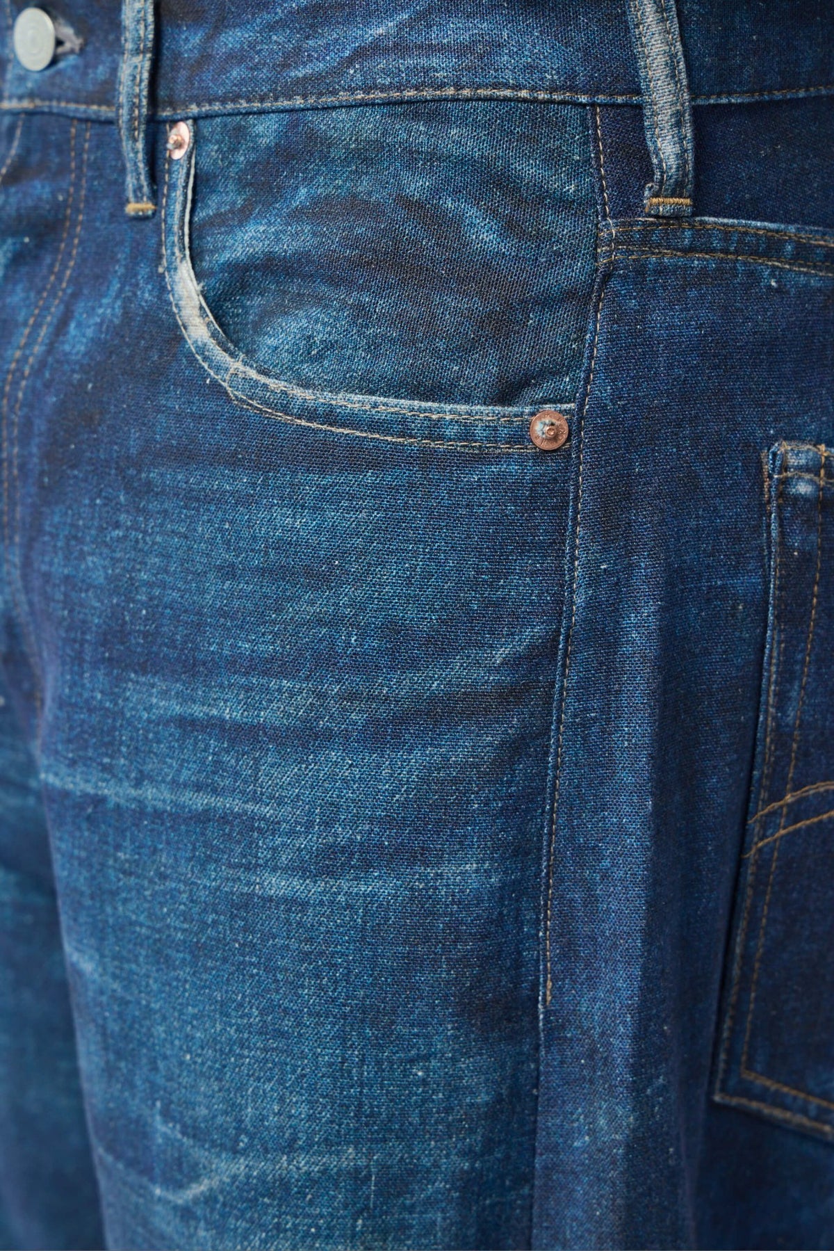 Side view of Junya Watanabe wide-leg pants highlighting the flowing silhouette