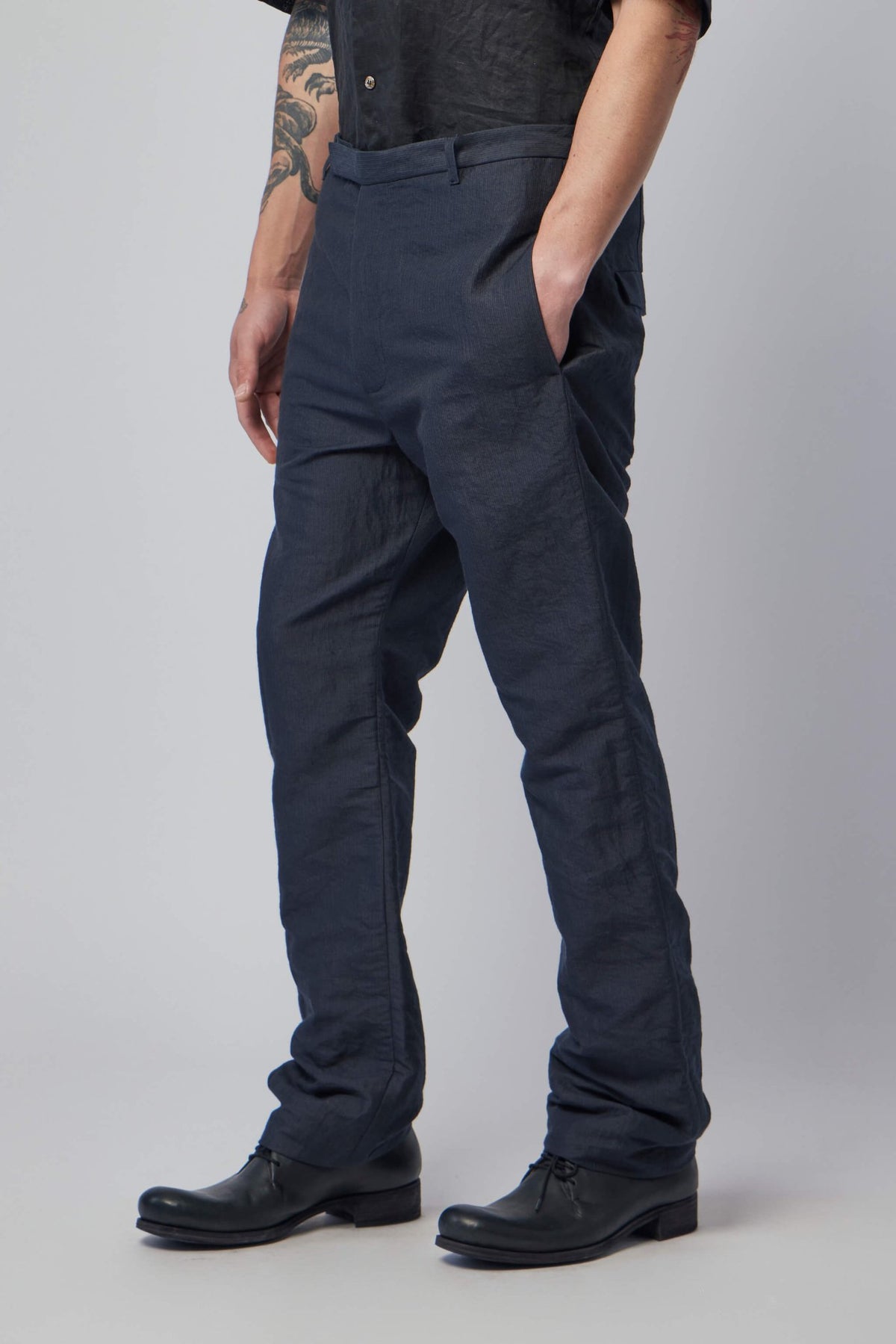Model wearing K'ang men's fitted trousers styled for sophisticated casual look