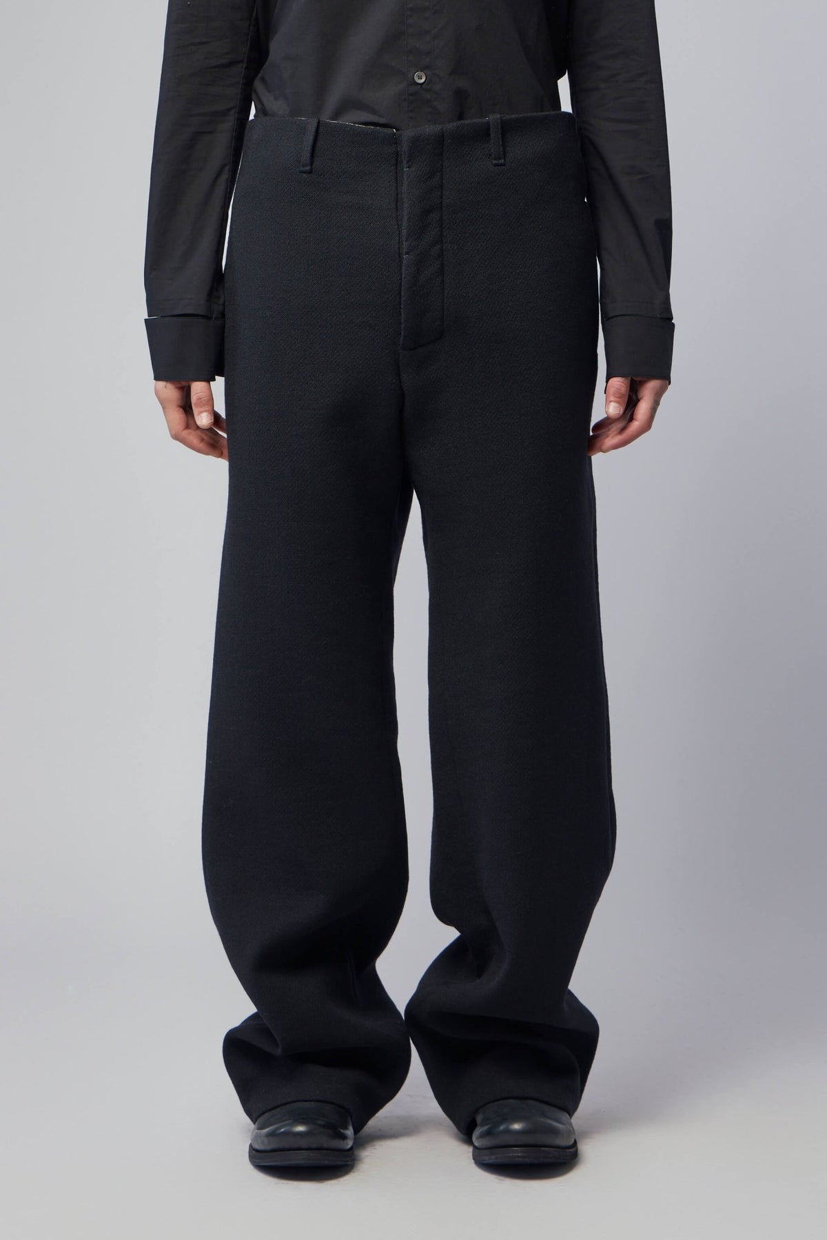 Close-up of adjustable back pleat detail on K'ANG trousers