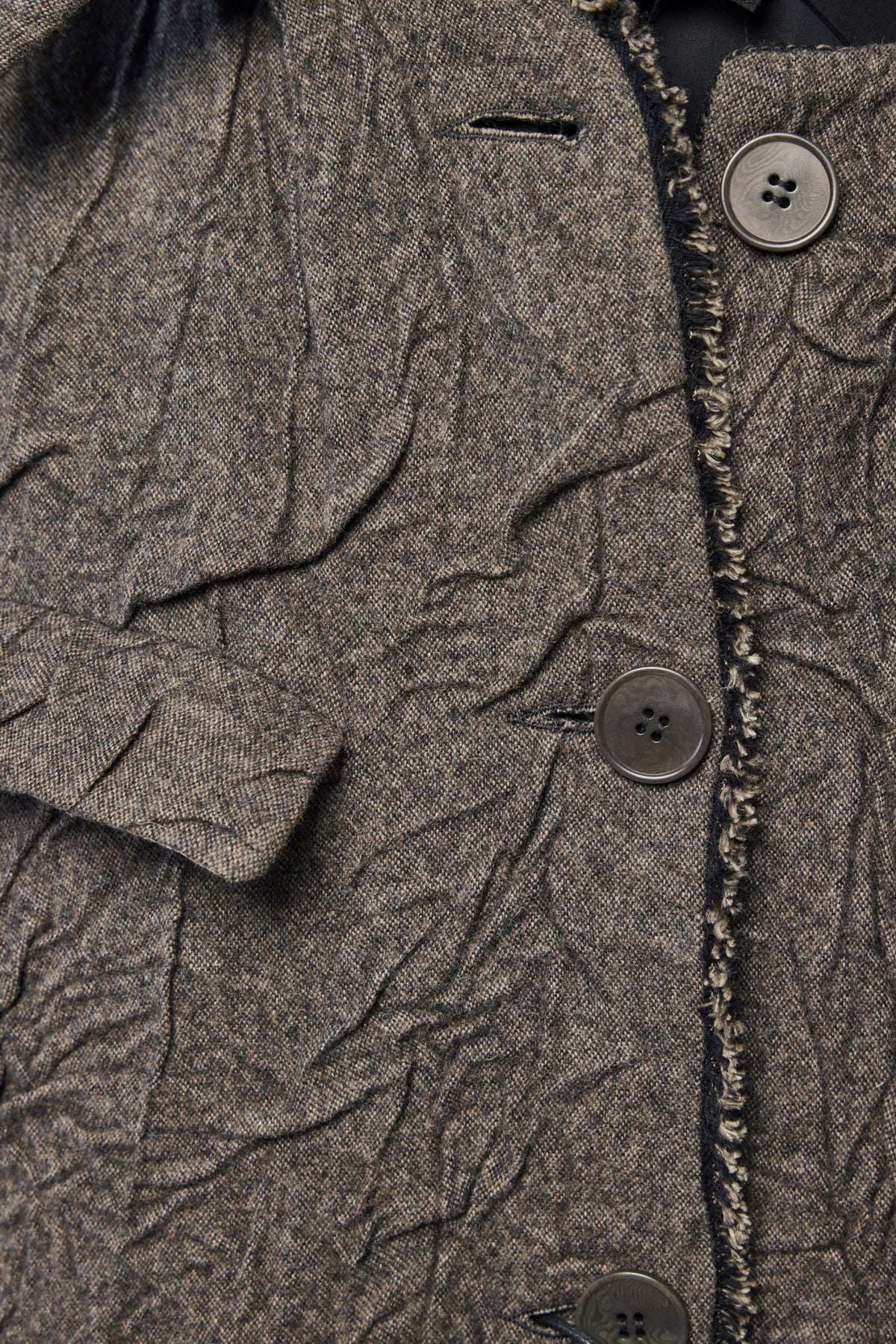 Detachable hood feature of K'ANG reversible coat showing versatile styling options
