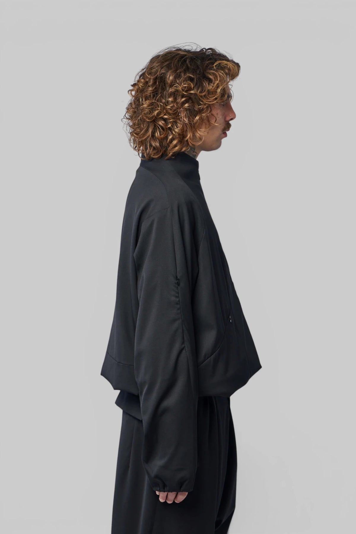 Model wearing Kiko Kostadinov Erdiko Jacket with relaxed fit
