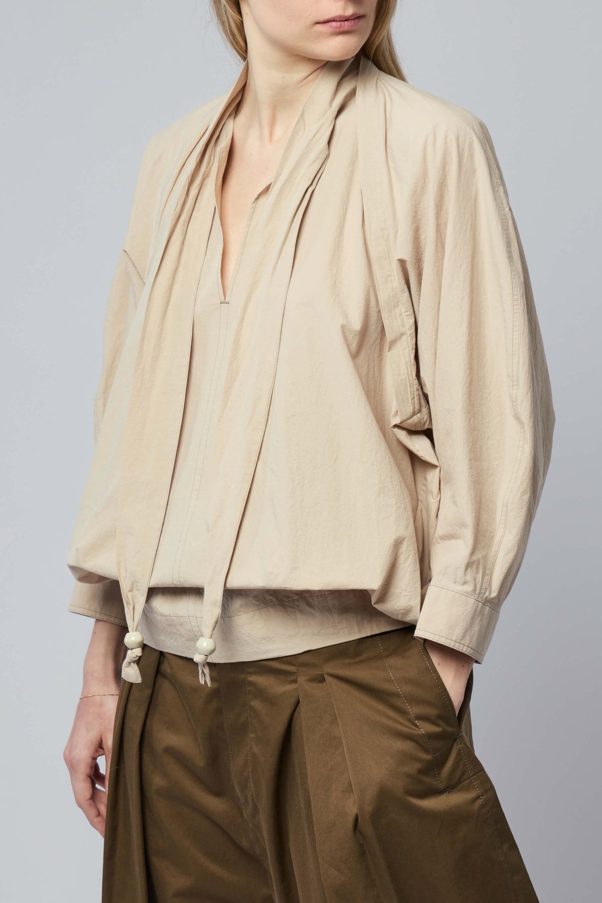 Side view of Lemaire blouse demonstrating elegant drape