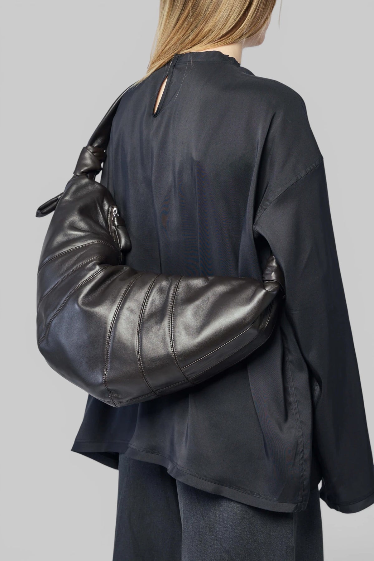 Side view of Lemaire Large Croissant Bag showing crescent shape