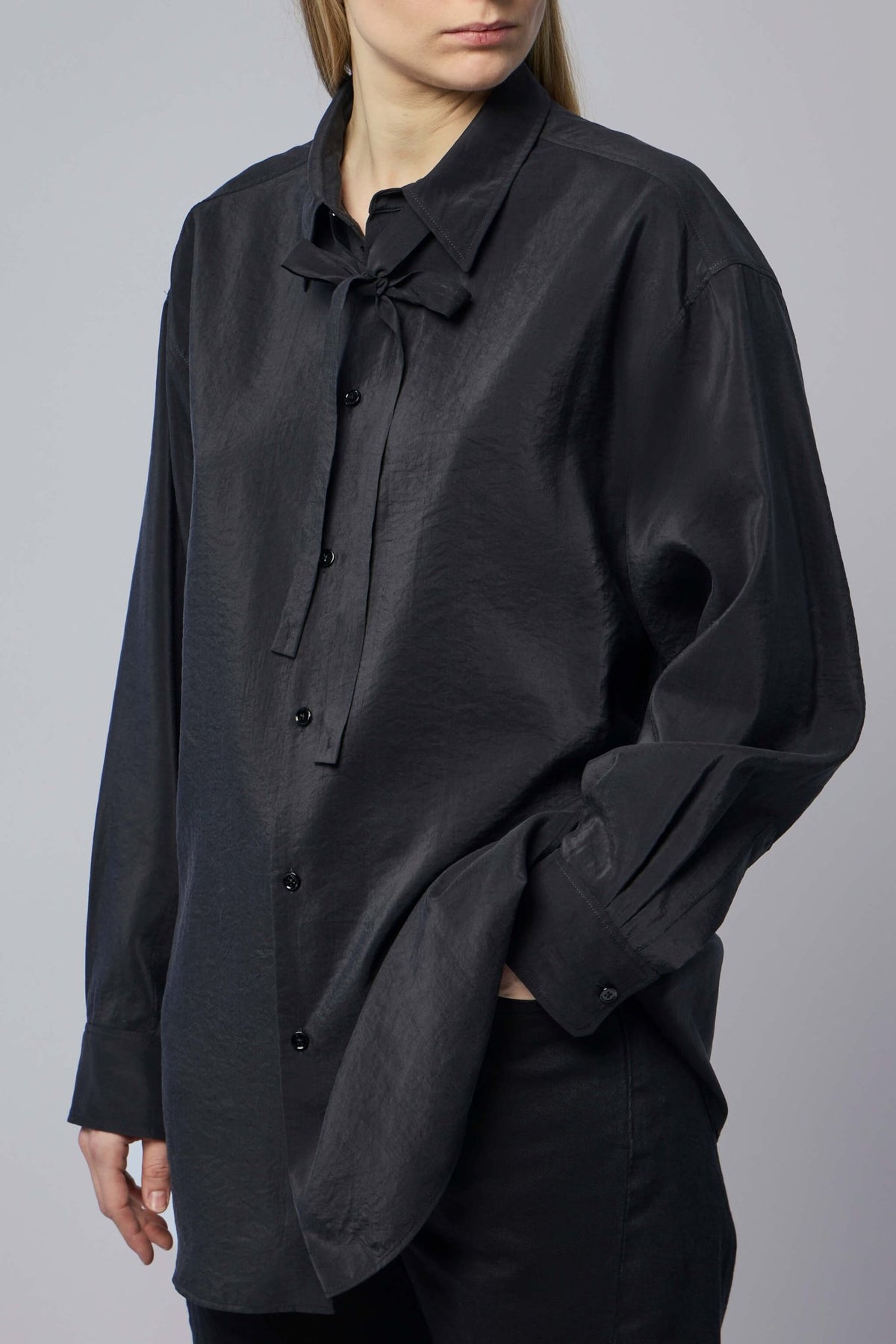 Close-up of tie-neck detail on Lemaire silk shirt
