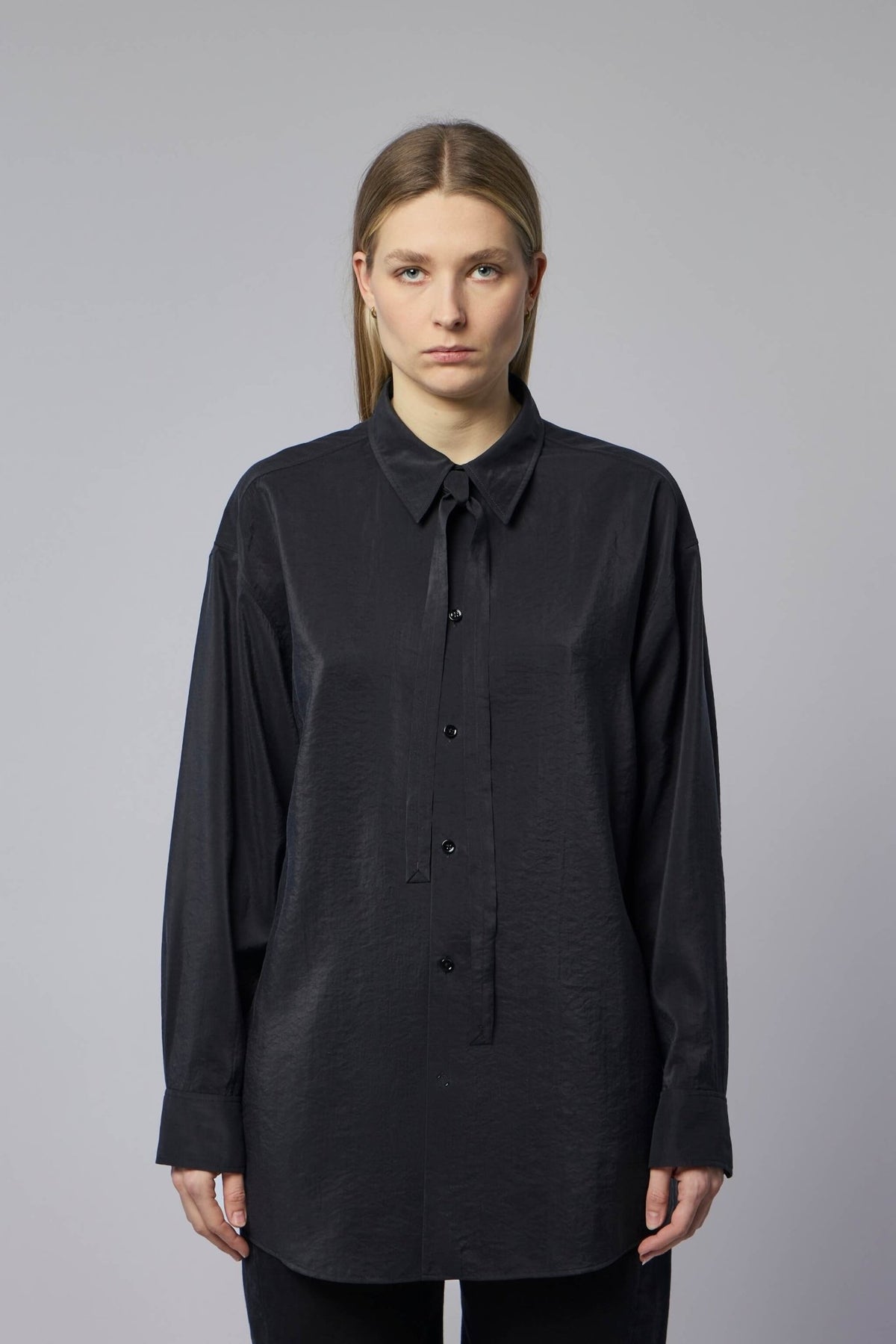 Model wearing Lemaire long shirt showing relaxed fit and button closure