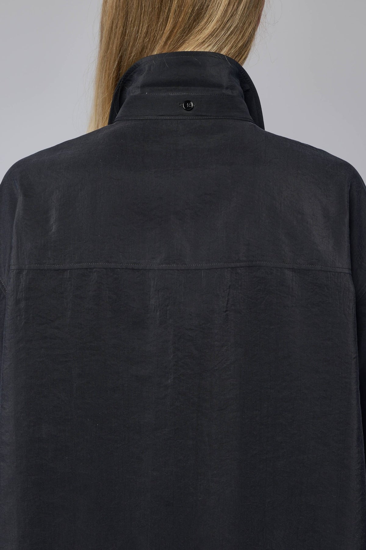 Detail shot of button closure on Lemaire silk shirt