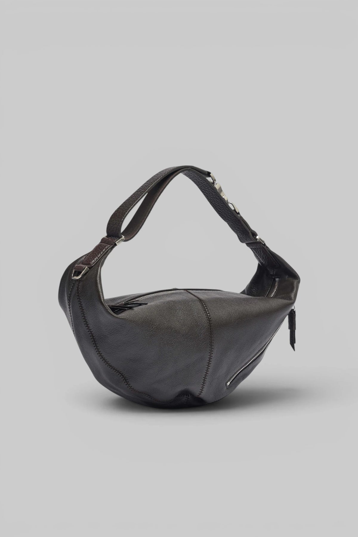 Close-up of silver-tone hardware on Lemaire Mini Quiver Clip Bag