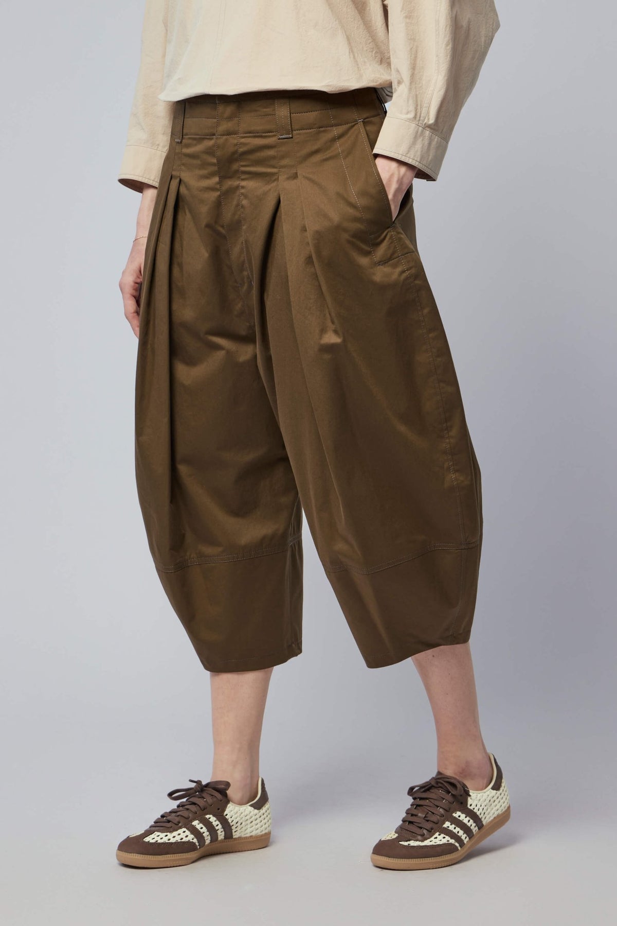 Model wearing Lemaire cotton bermudas styled with contemporary pieces