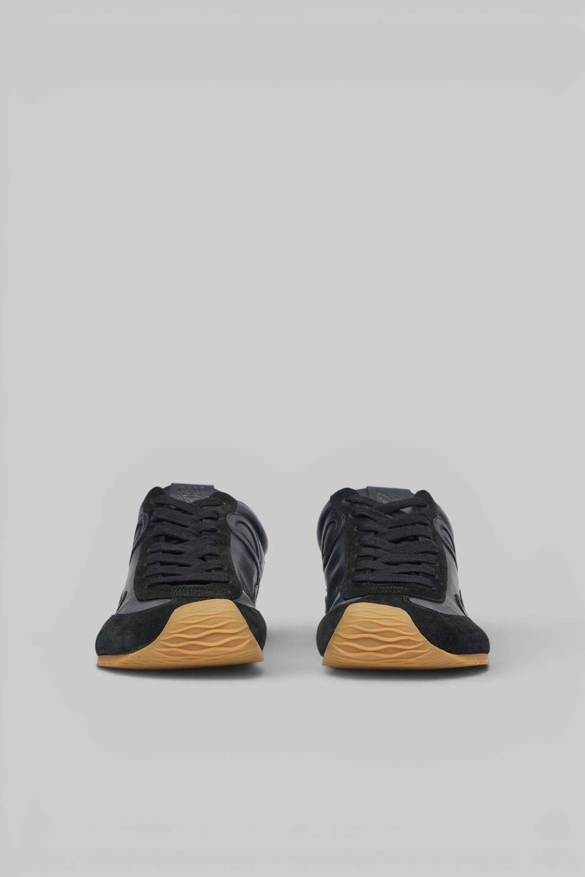 Side profile of Loewe leather sneaker with suede accents