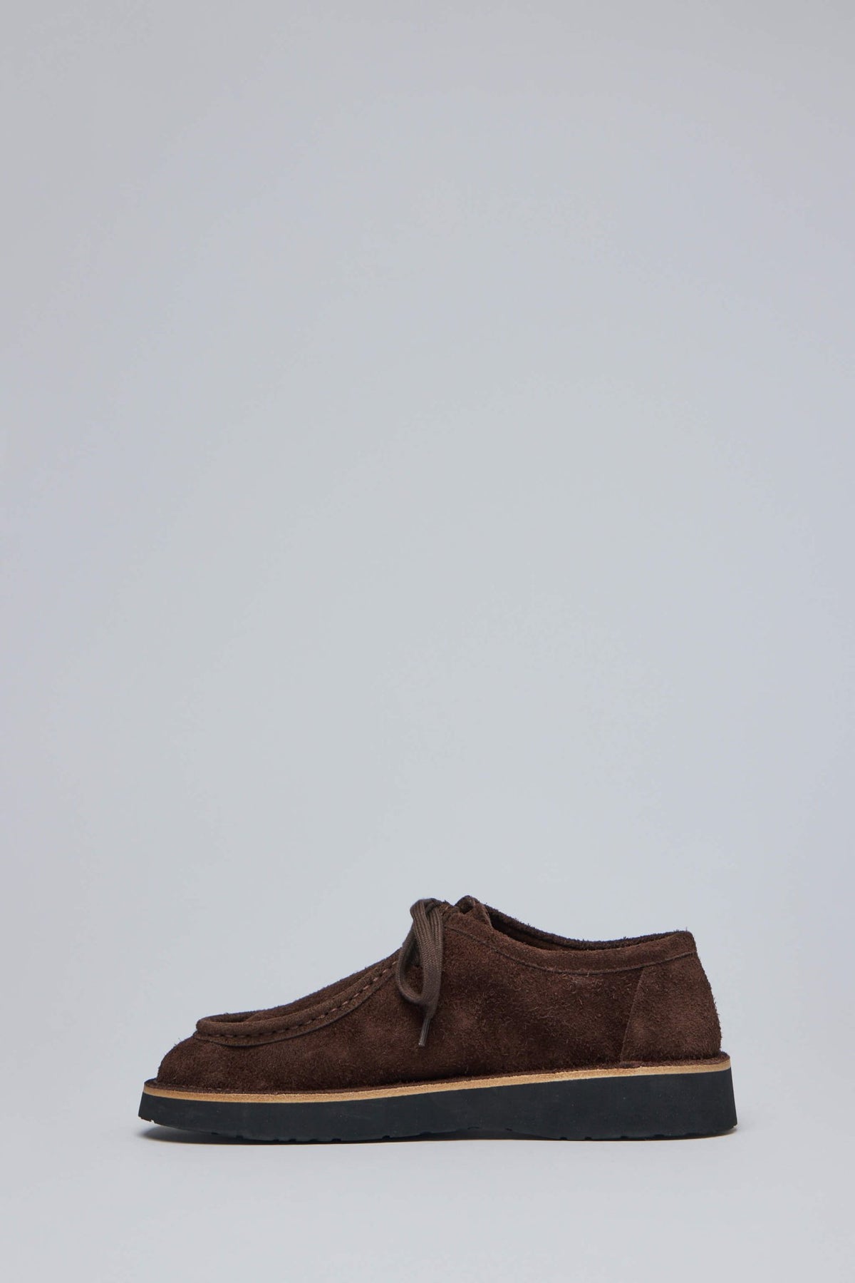 Side profile of Loewe Faro brown suede boots showing rounded toe