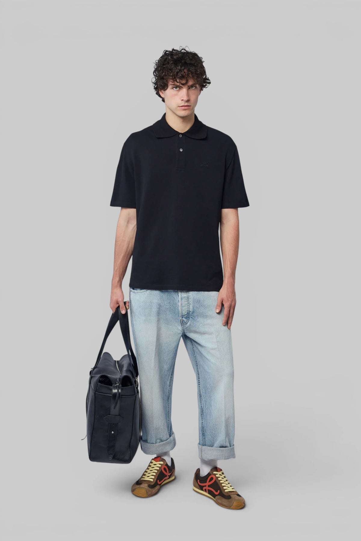 Close-up of Loewe polo shirt buttoned placket and logo