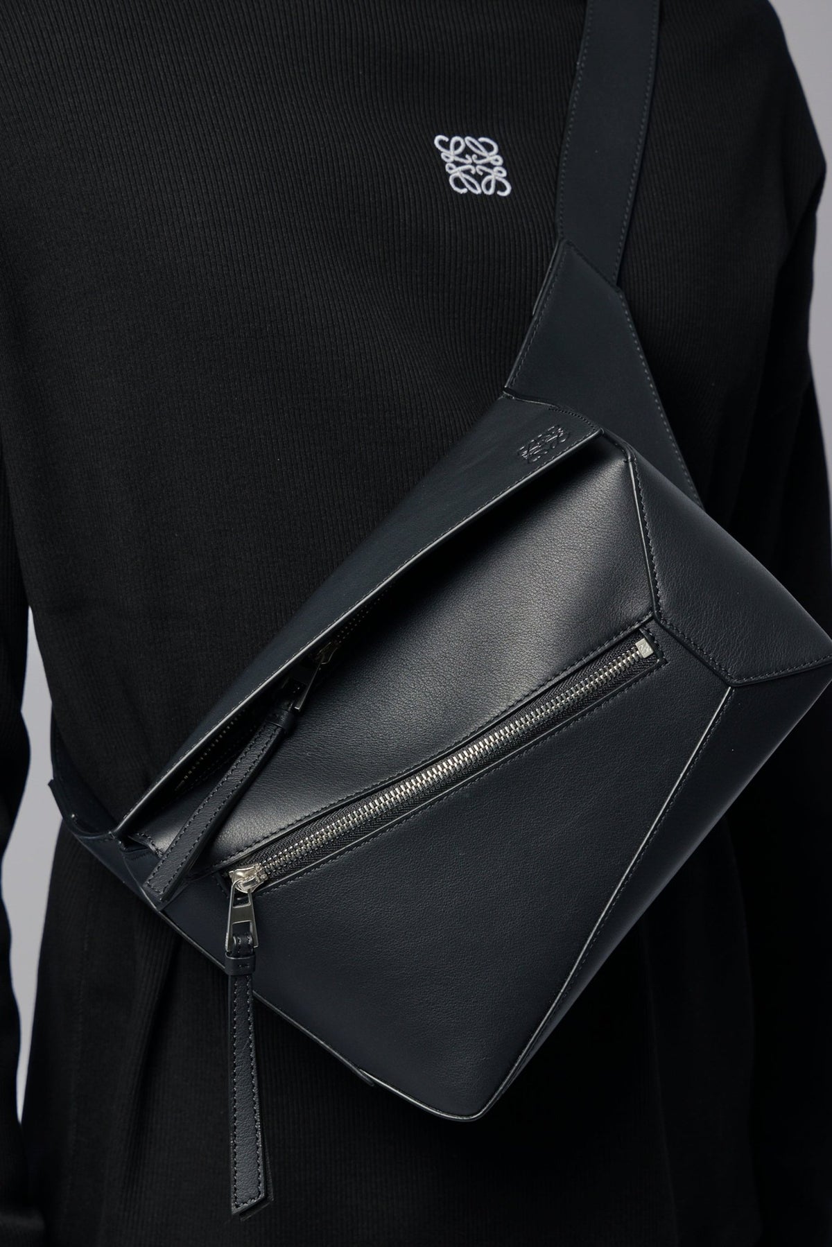 Detail shot of Loewe bag's smooth leather finish and geometric angular shape