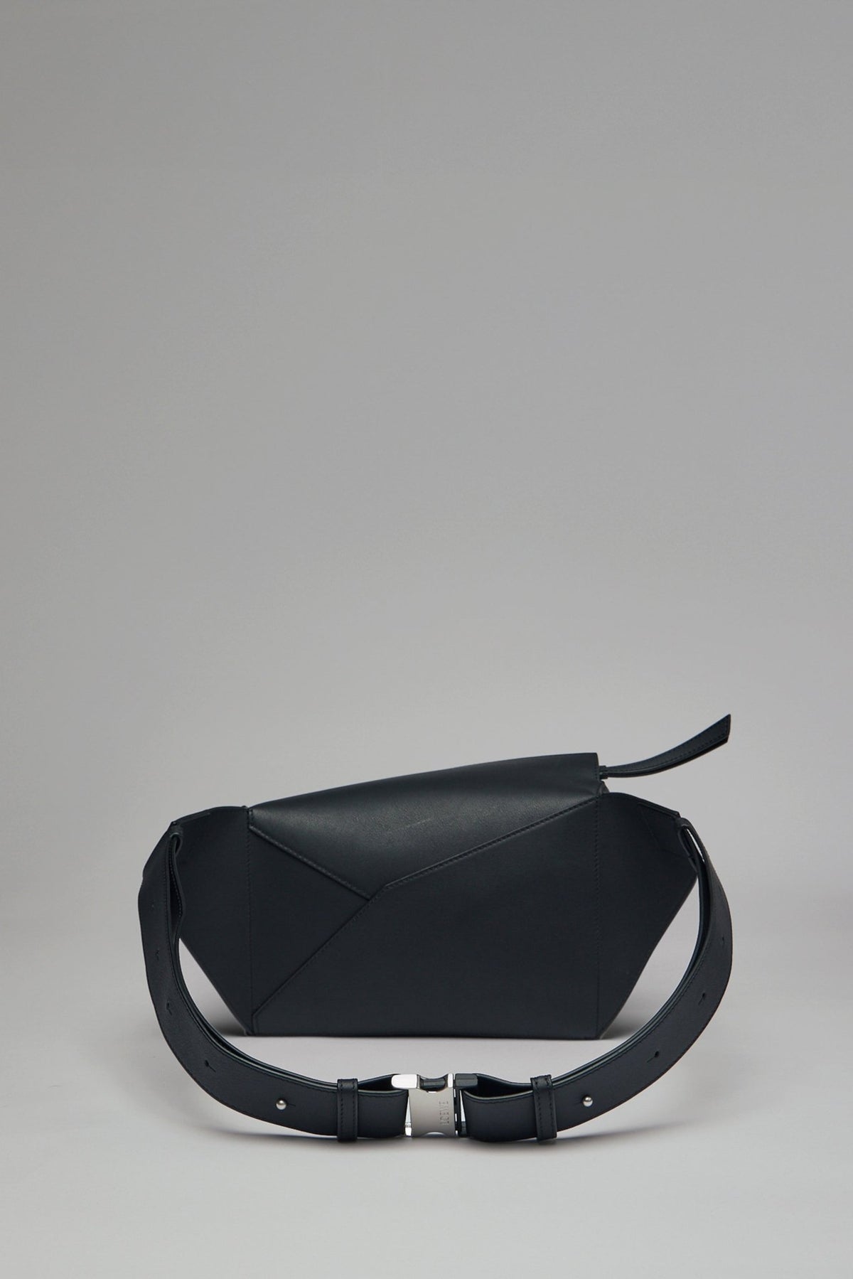 Close-up of Loewe Puzzle Edge bumbag showing front zipper pocket and silver hardware