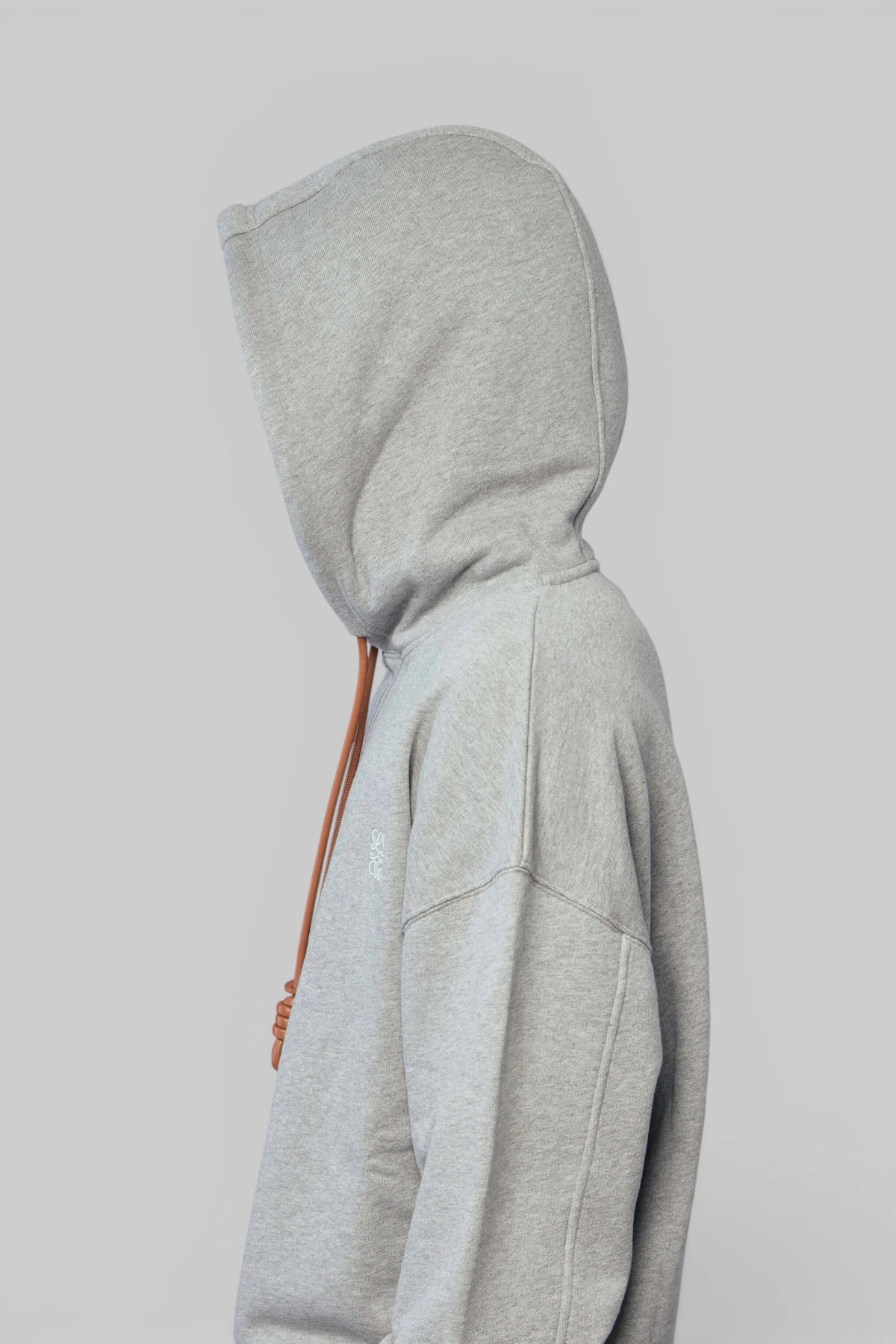 Hoodie styling detail showing ribbed hem and sleeve construction