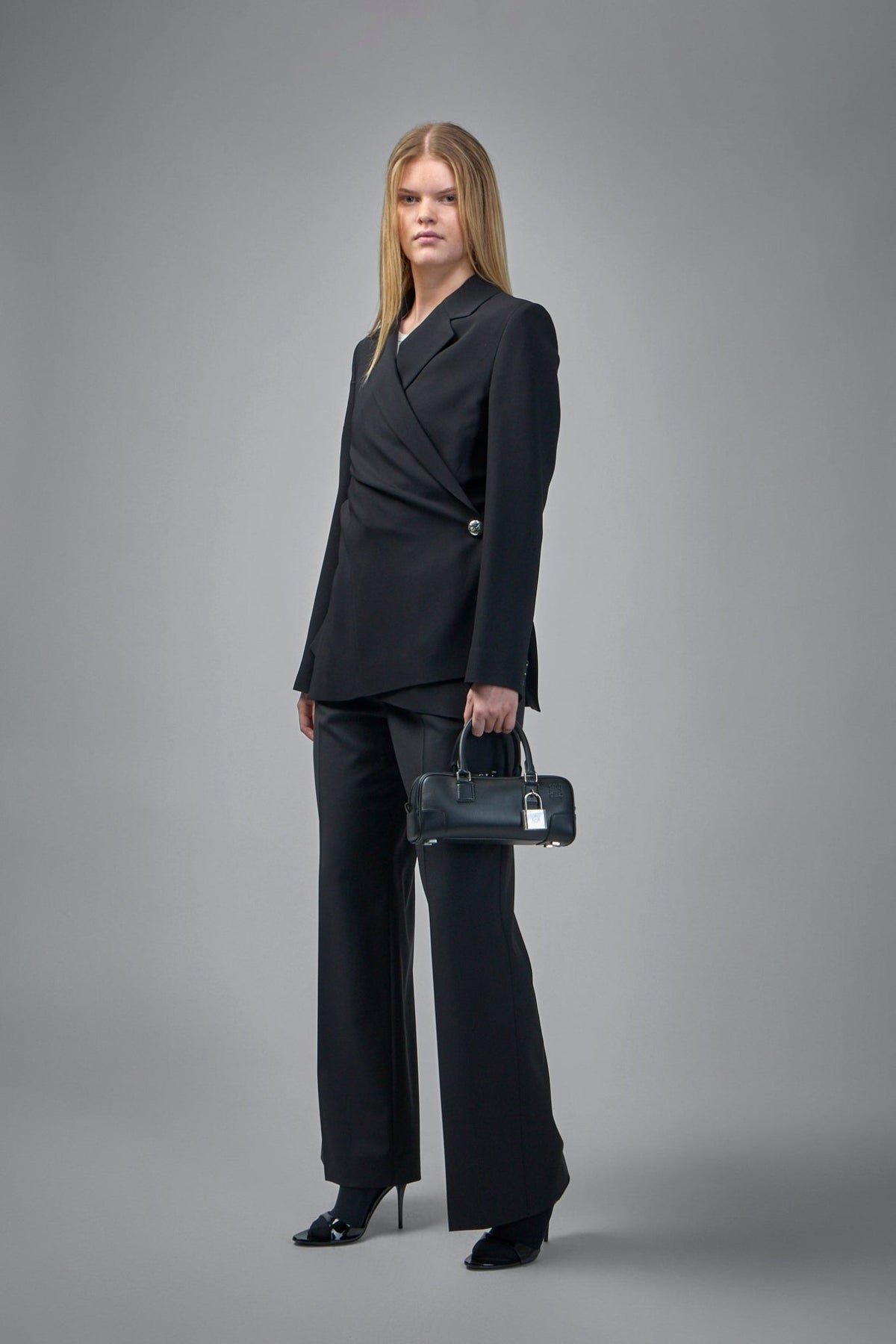 Close-up of asymmetrical button detail on Loewe tailored jacket