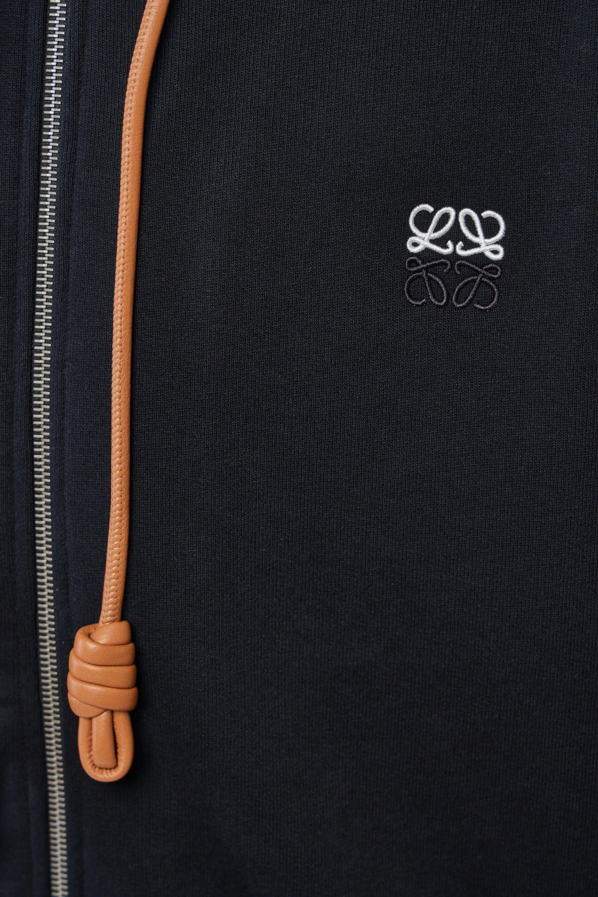 Close-up of Loewe anagram logo embroidery on hoodie chest