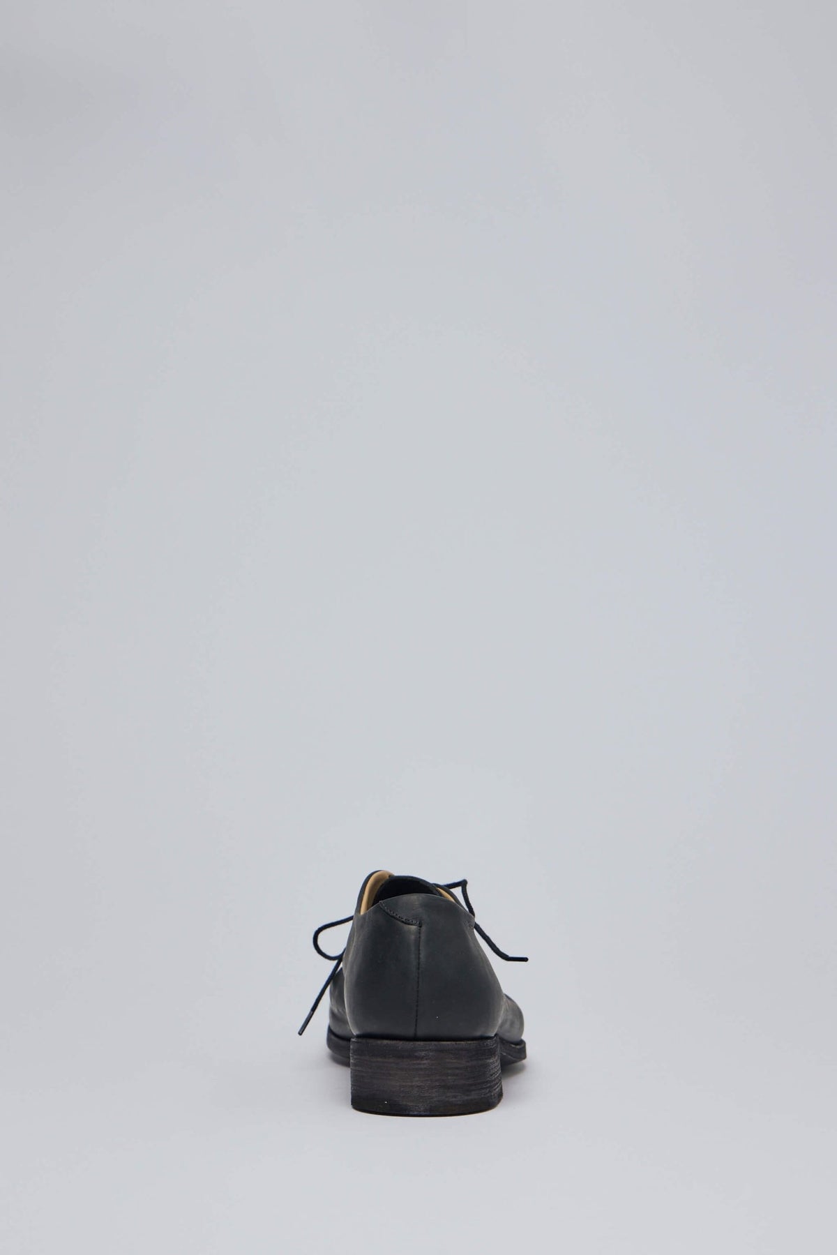 Detail shot of lace-up closure and stacked heel design