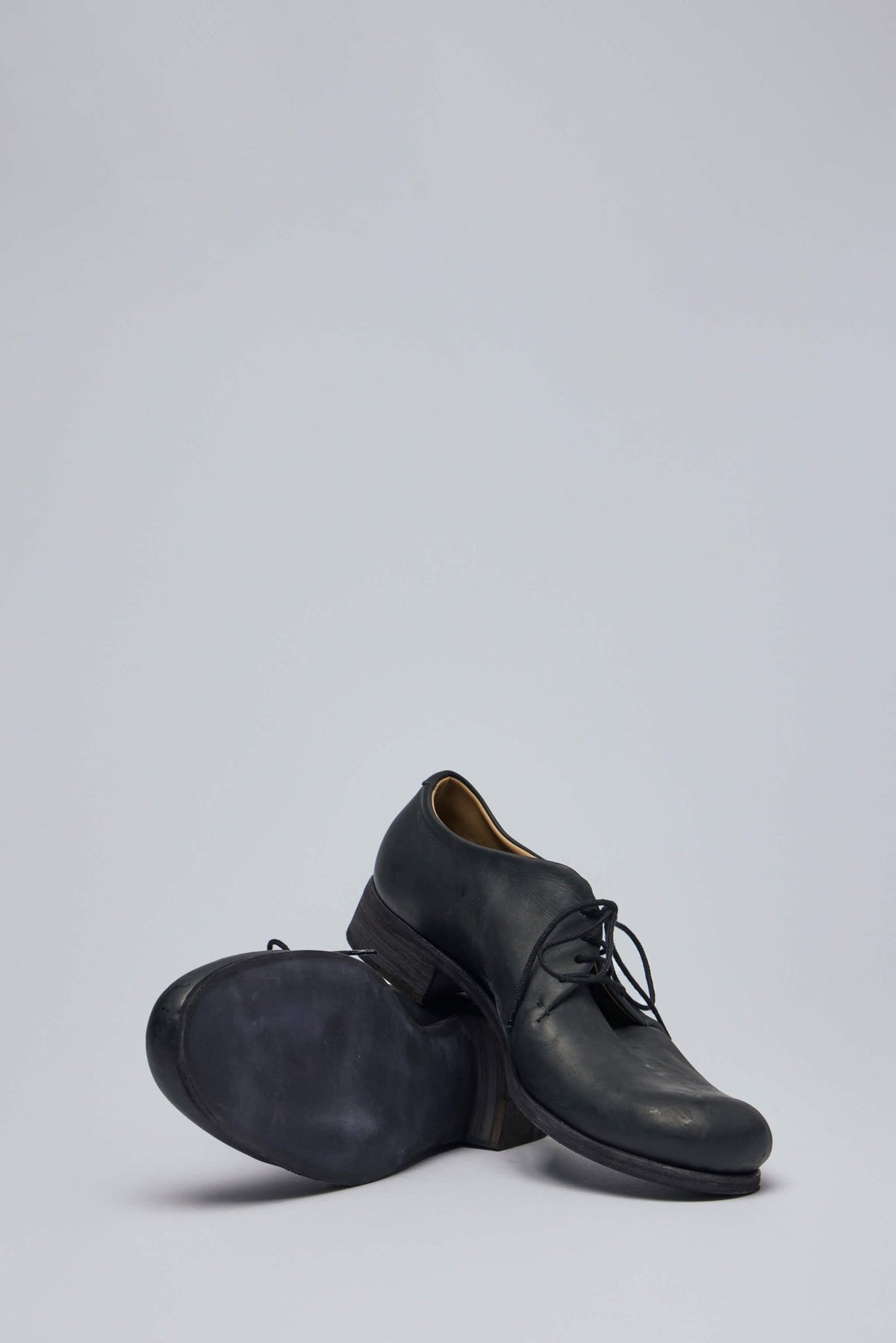 Full view of M.A+ black leather flats on neutral background