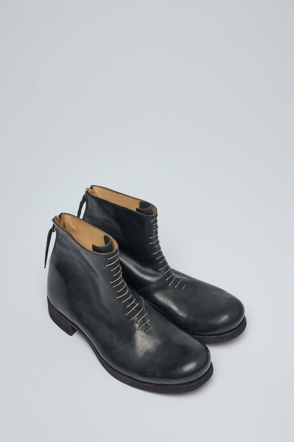 Close-up view of minimalist boot construction and leather texture