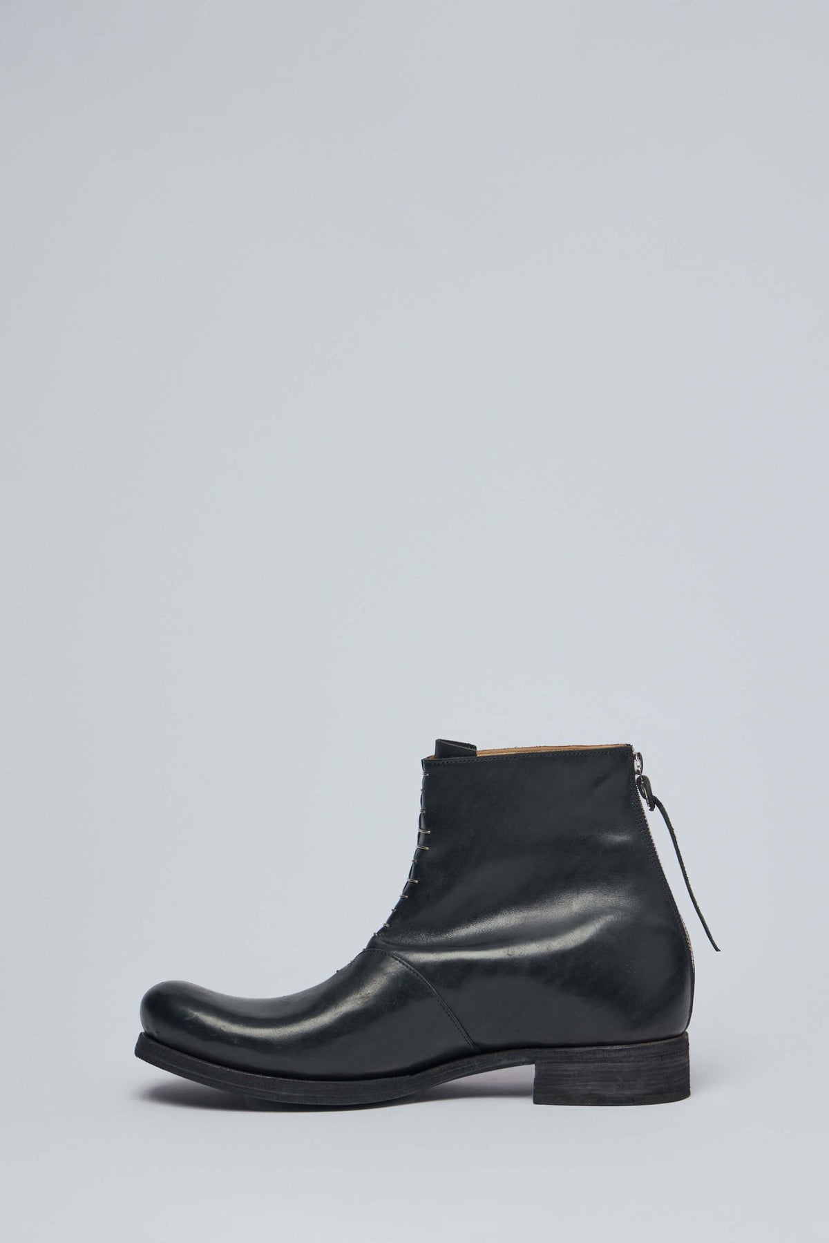 Side profile showing distinctive back zipper closure system