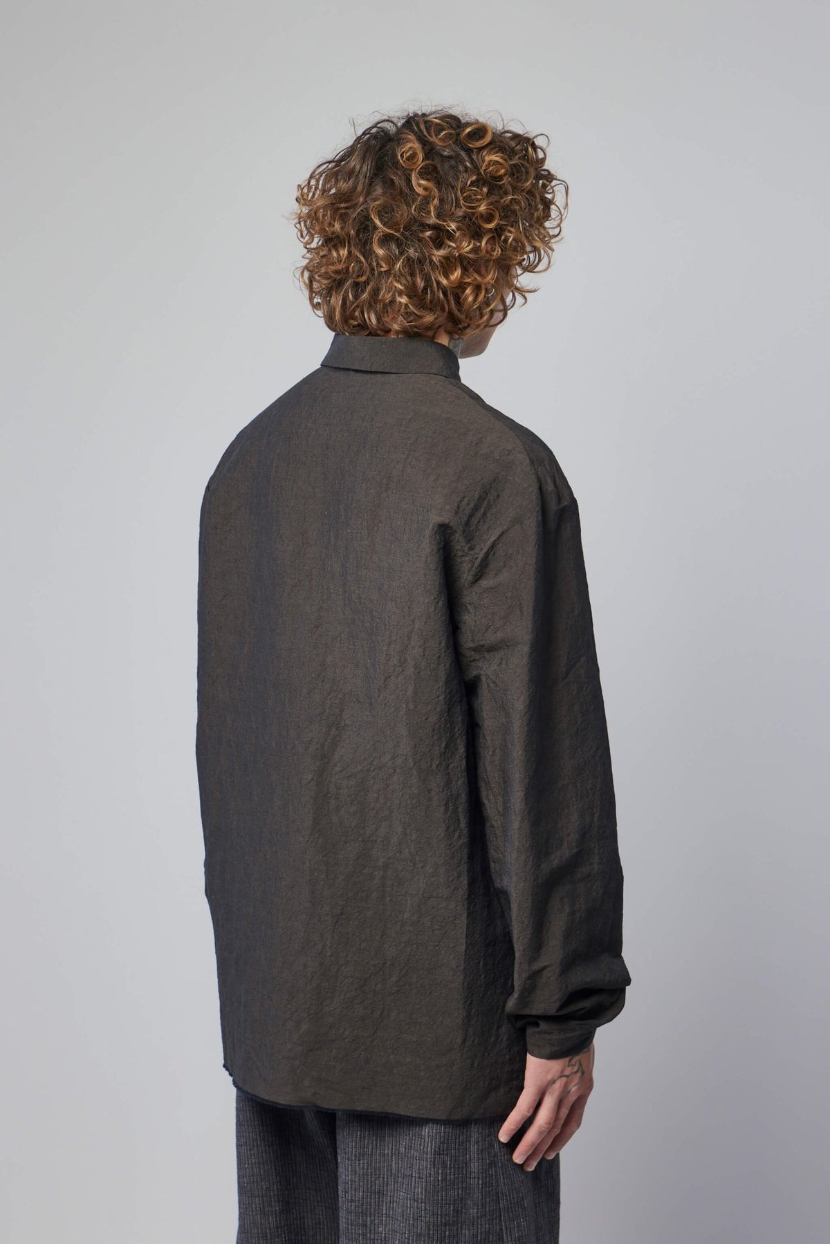 Flat lay styling of M.A+ shirt with contemporary menswear pieces