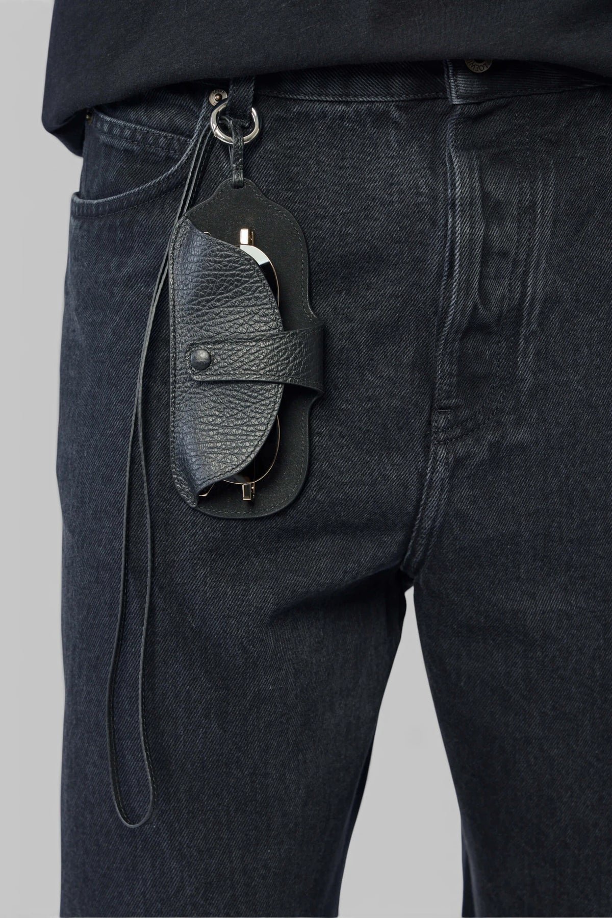 Close-up of brass hardware on Maison Margiela leather pouch