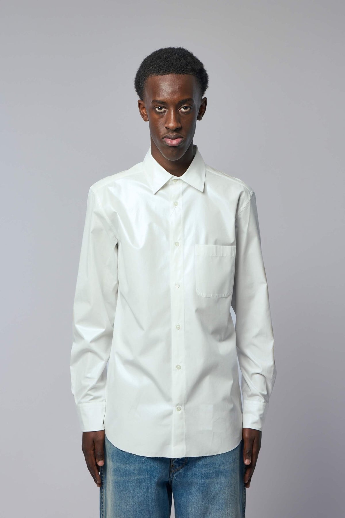 Close-up of Maison Margiela shirt showing button-down front and chest pocket detail