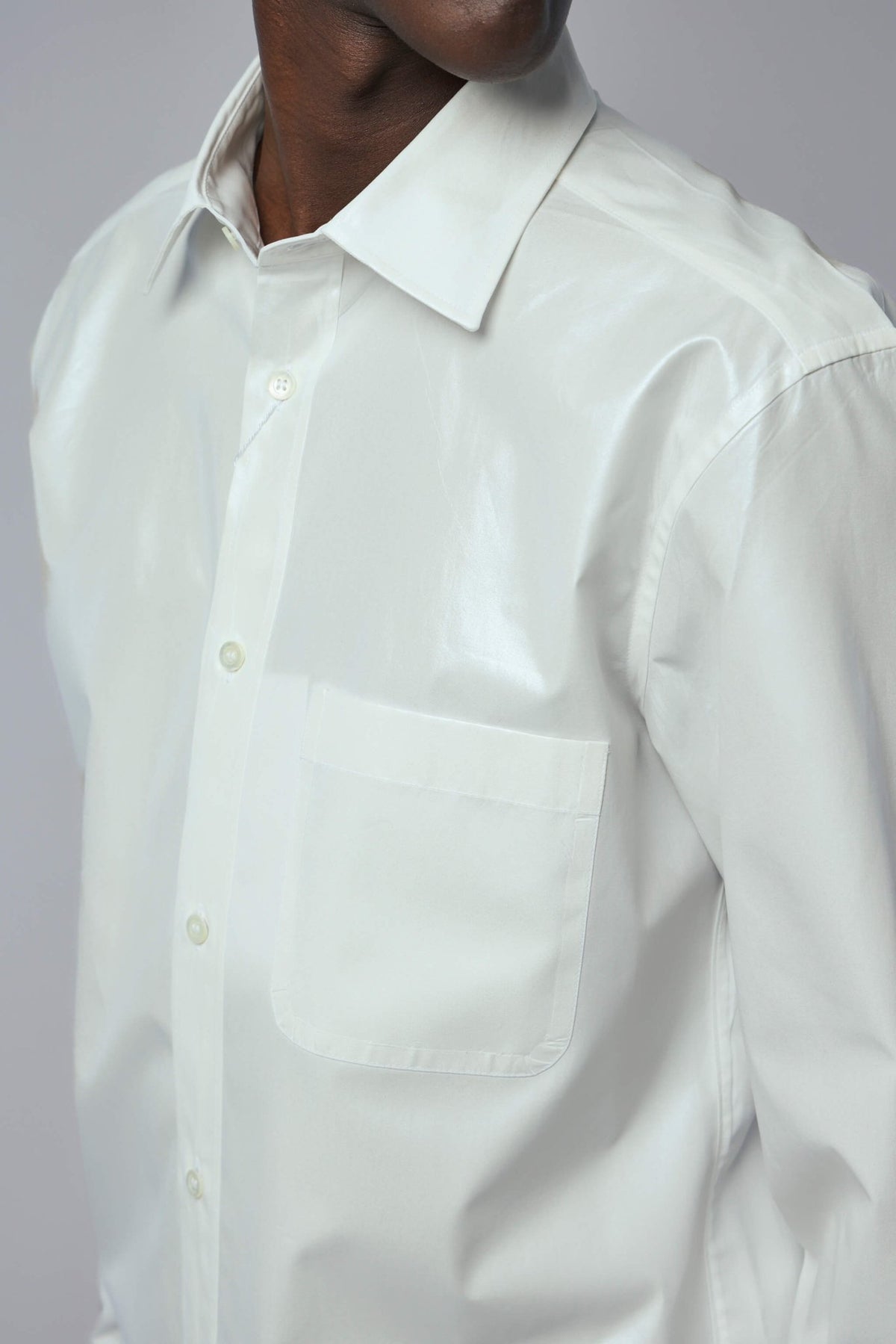 Side view of long-sleeved Maison Margiela shirt displaying clean lines and tailored fit