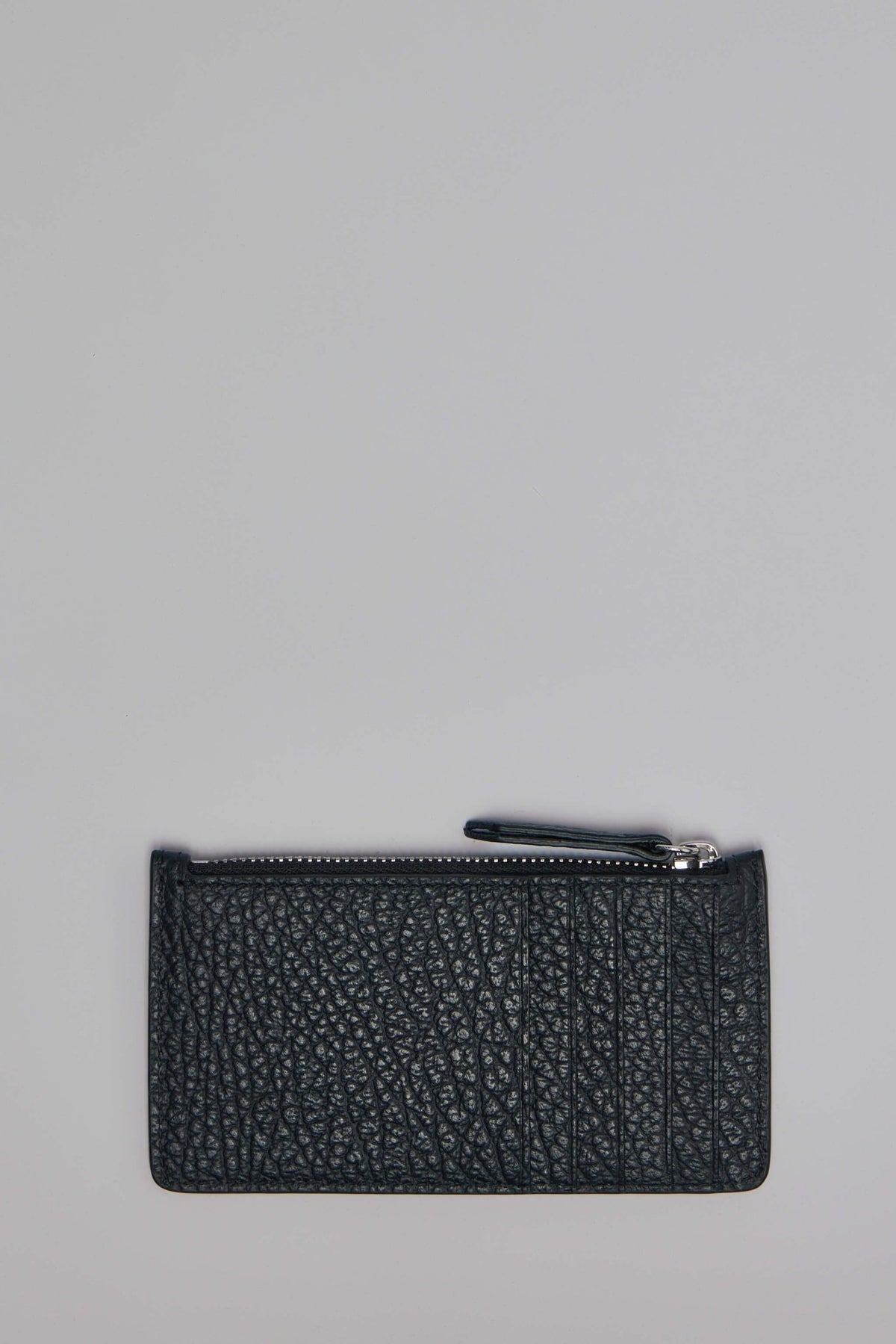 Close-up view of Maison Margiela cardholder showing zip closure and leather texture
