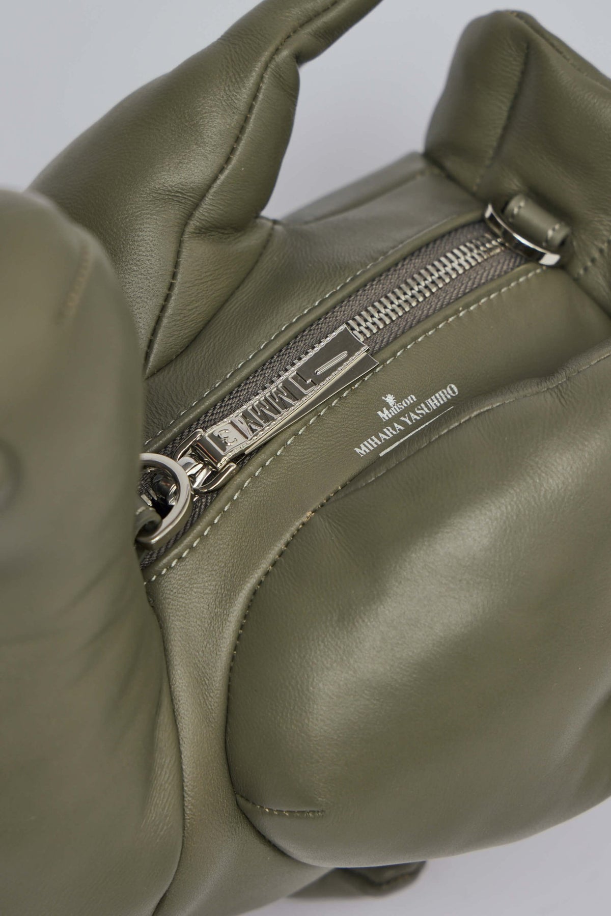Interior view of spacious compartment in Maison Mihara Yasuhiro shoulder bag