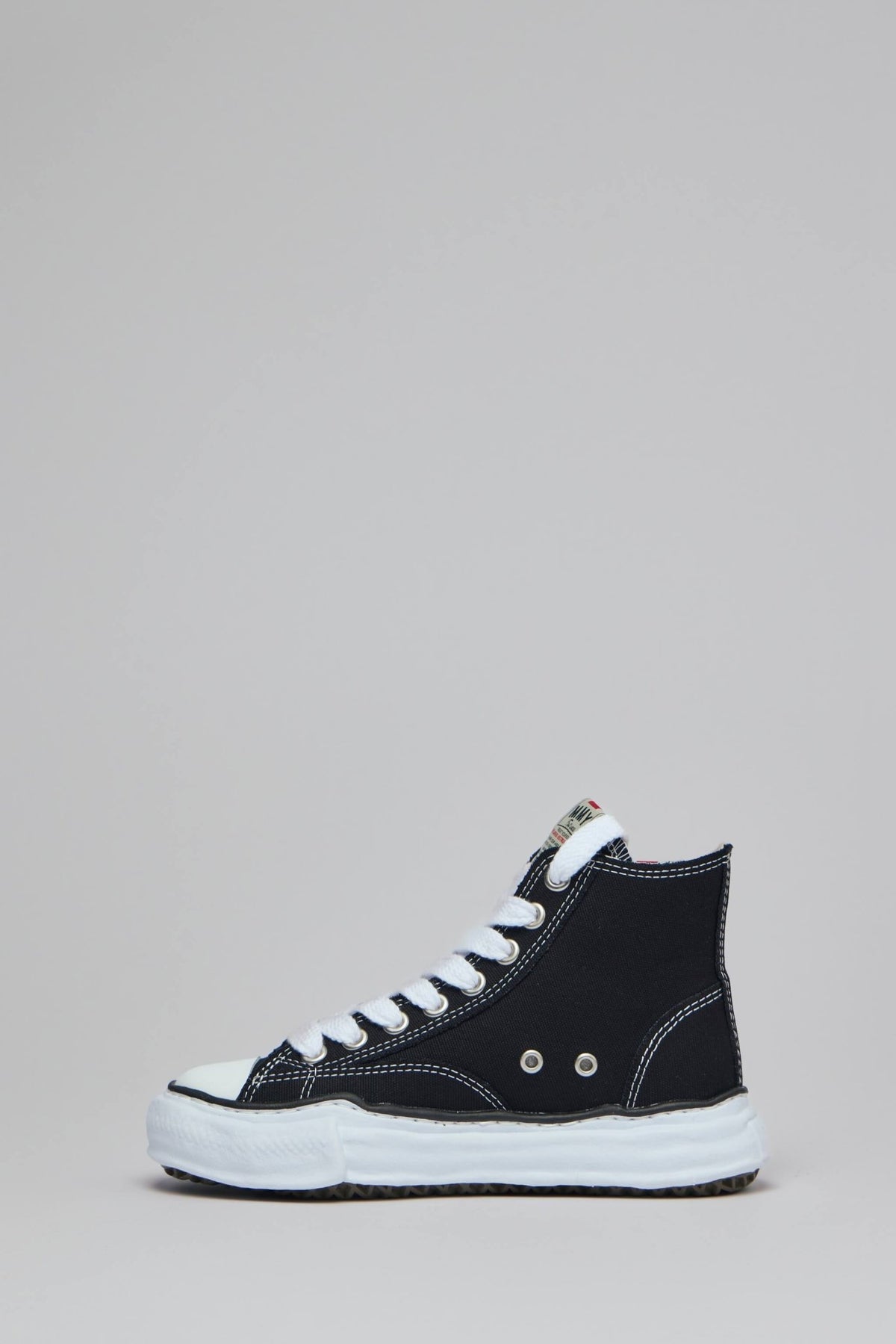 High top sneaker back view displaying contrasting white stitching
