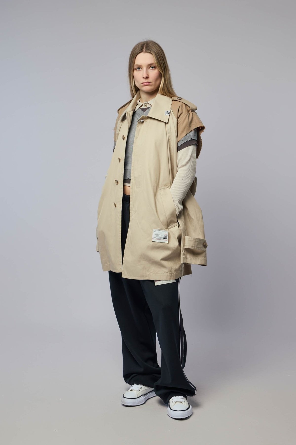Styling shot of balmacaan coat worn open over casual outfit