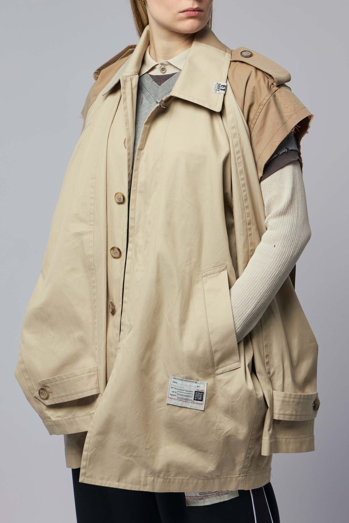 Side view of oversized balmacaan coat featuring functional pockets