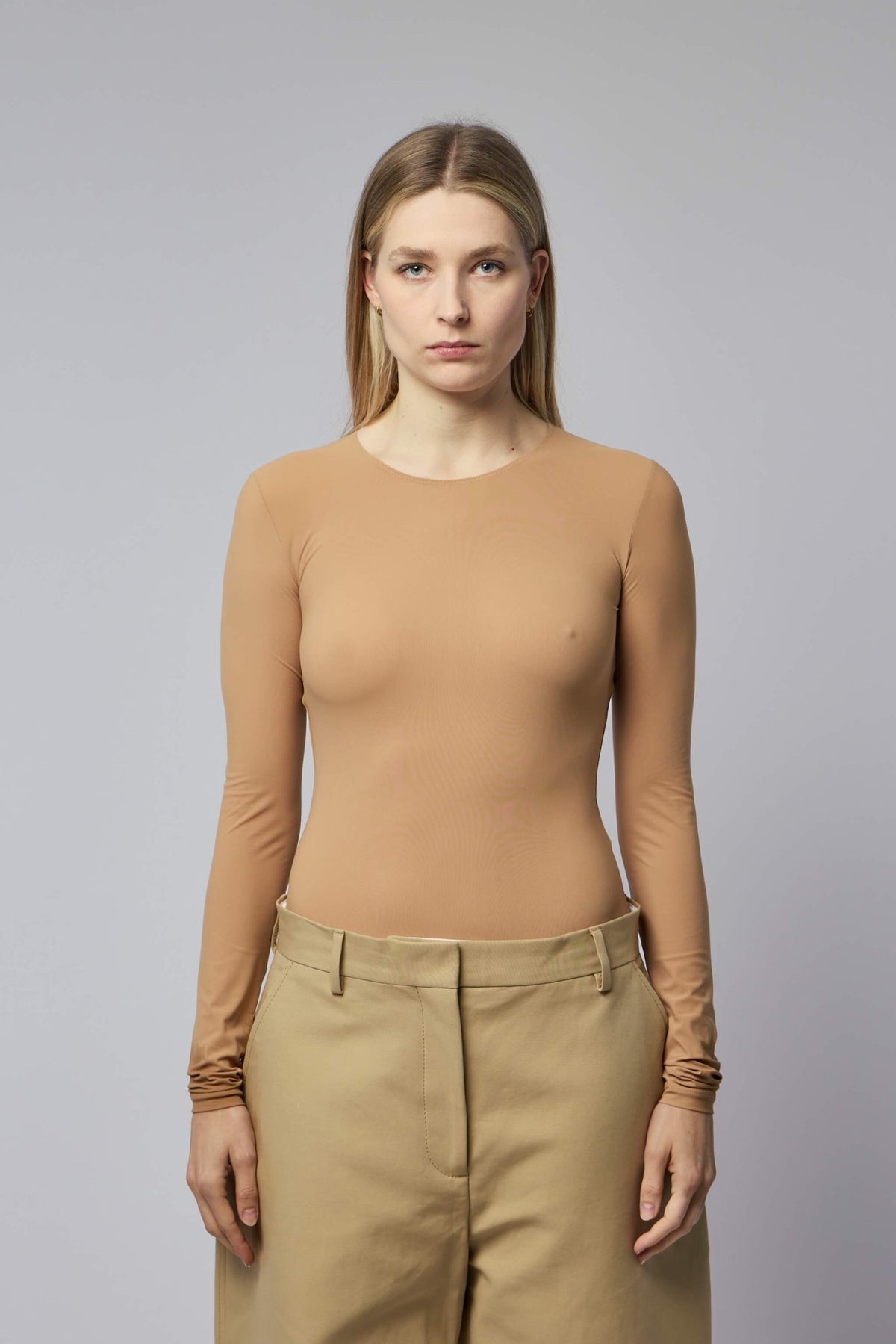 Close-up detail of MM6 Margiela bodysuit showing smooth fabric texture