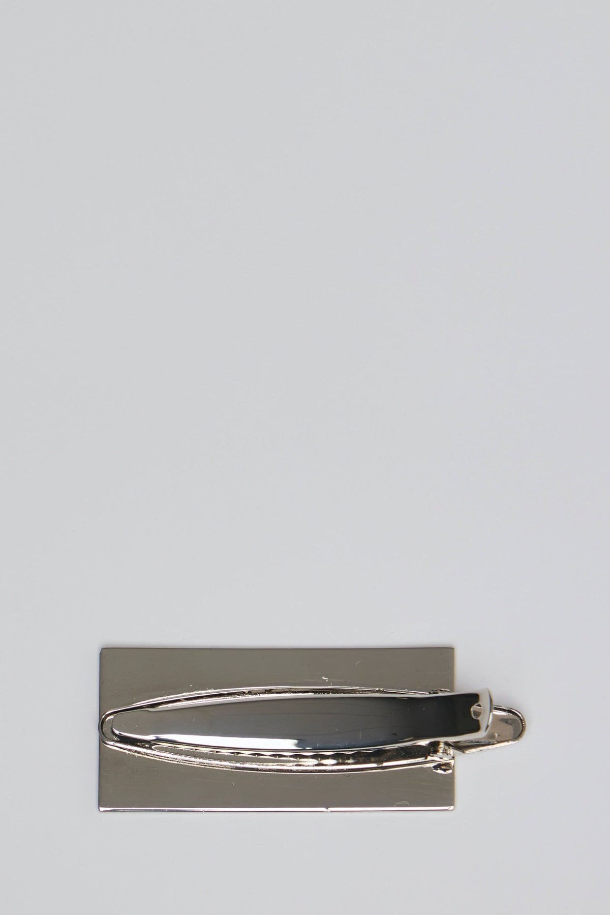 Close-up view of rectangular metal hair clip with numerical pattern