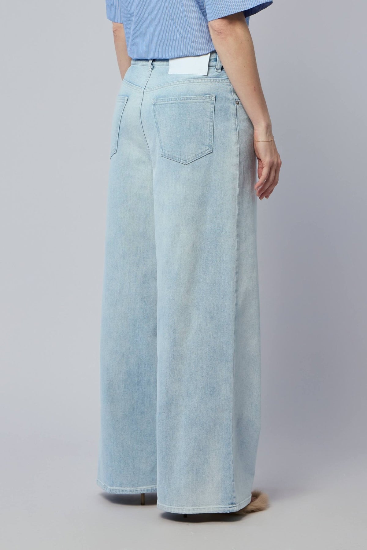 Back view of MM6 Margiela five-pocket jeans showing classic denim styling