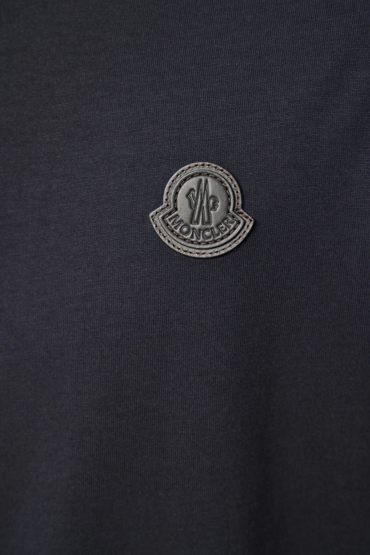 Moncler SS T-shirt worn with casual outerwear