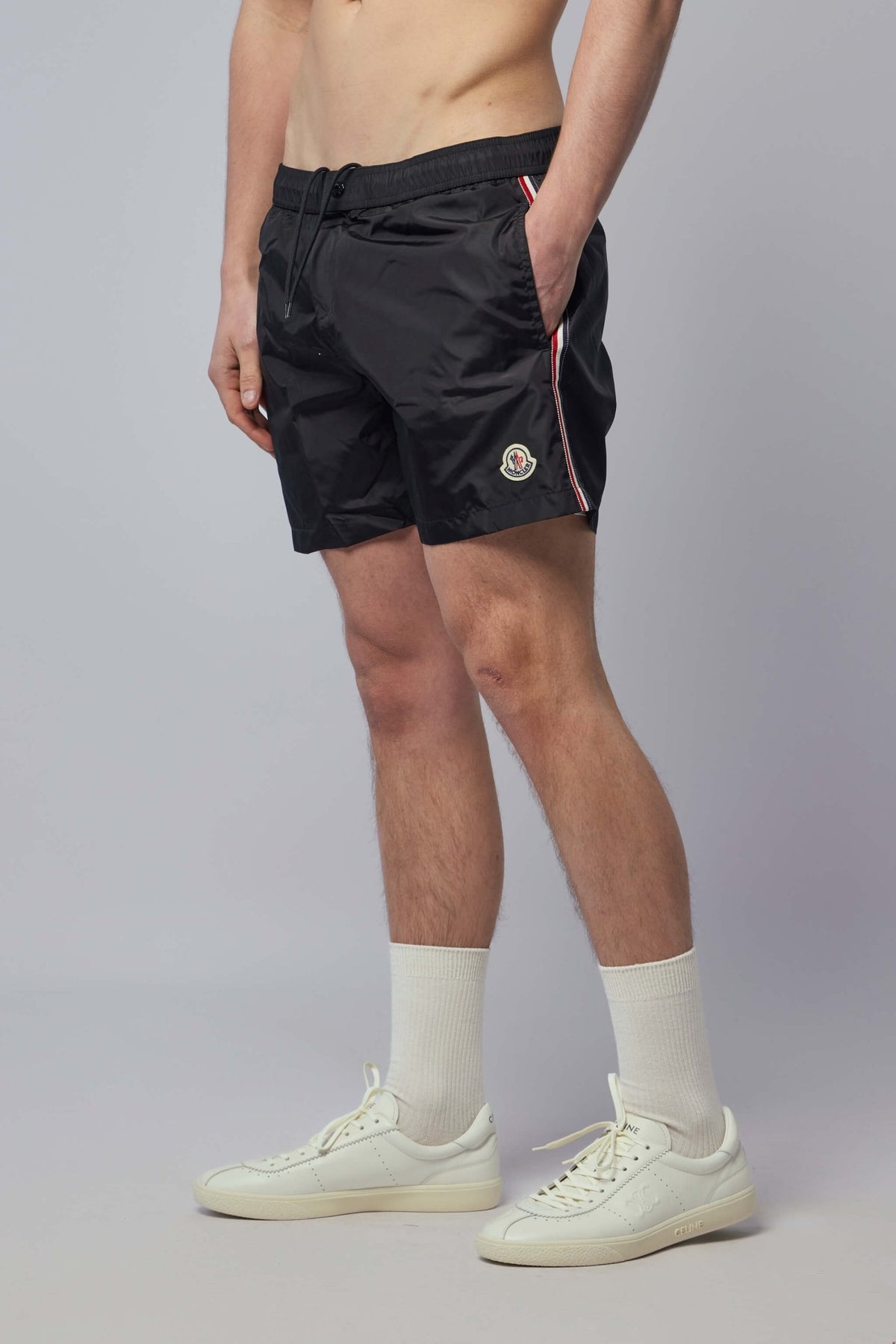 Side view showing distinctive stripes on Moncler swimwear
