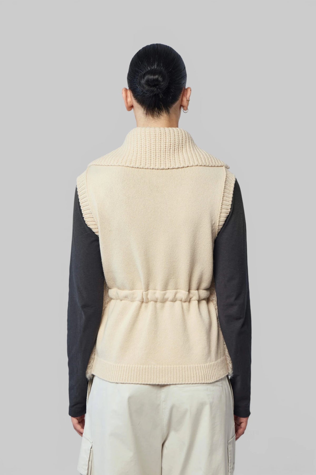 Detail shot of Moncler vest front pockets and knit trim