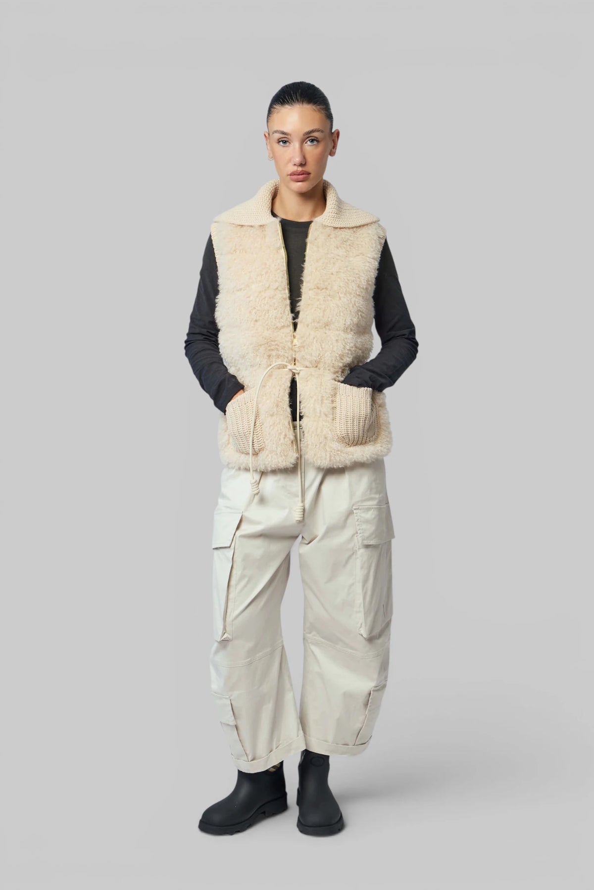 Close-up of Moncler down vest front zip and drawstring closure